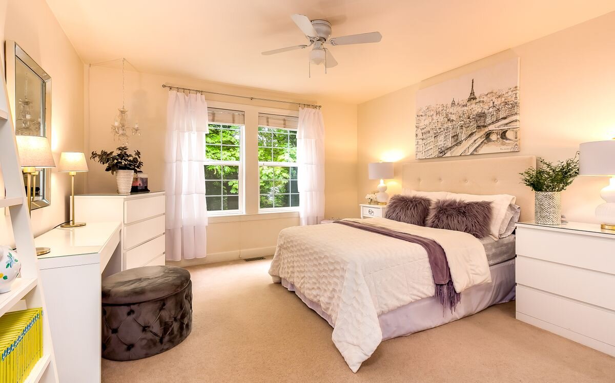  Each bedroom is roomy, with ample closet space, and has double hung windows for excellent ventilation. In addition, the newer lighting has a ceiling fan. This bedroom overlooks the greenery and lovely flowering rhododendrons in the front yard. 