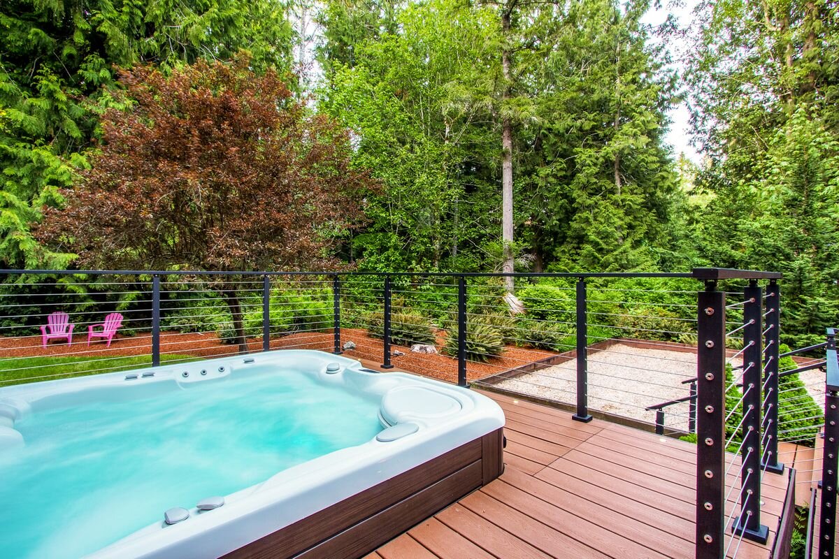  The newer Hot Springs salt water hot tub has a lovely view of the ornamental trees and privacy buffer in the backyard. 