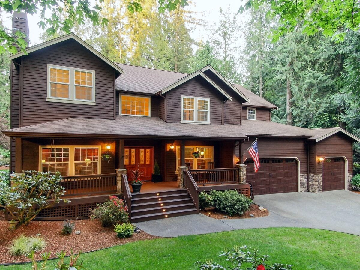 Such a beautiful home with an expansive covered front porch. It is reminiscent of a Tahoe-style lodge home or a classic farmhouse. The exterior is wood with stone accent and recently painted. 