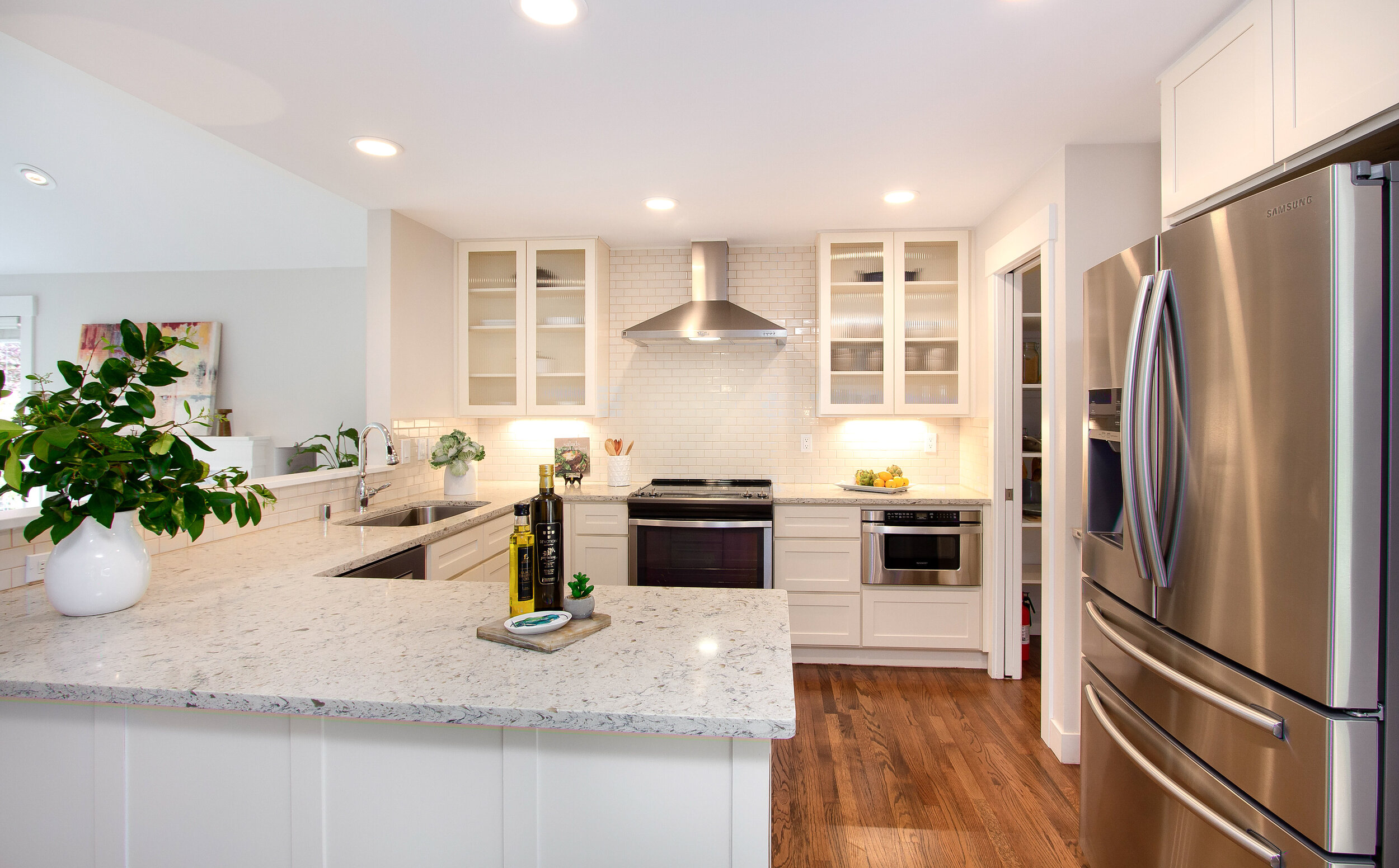  Enjoy this stunning kitchen, complete with beautiful white stone counters and updated stainless steel appliances, as you whip up a meal. 