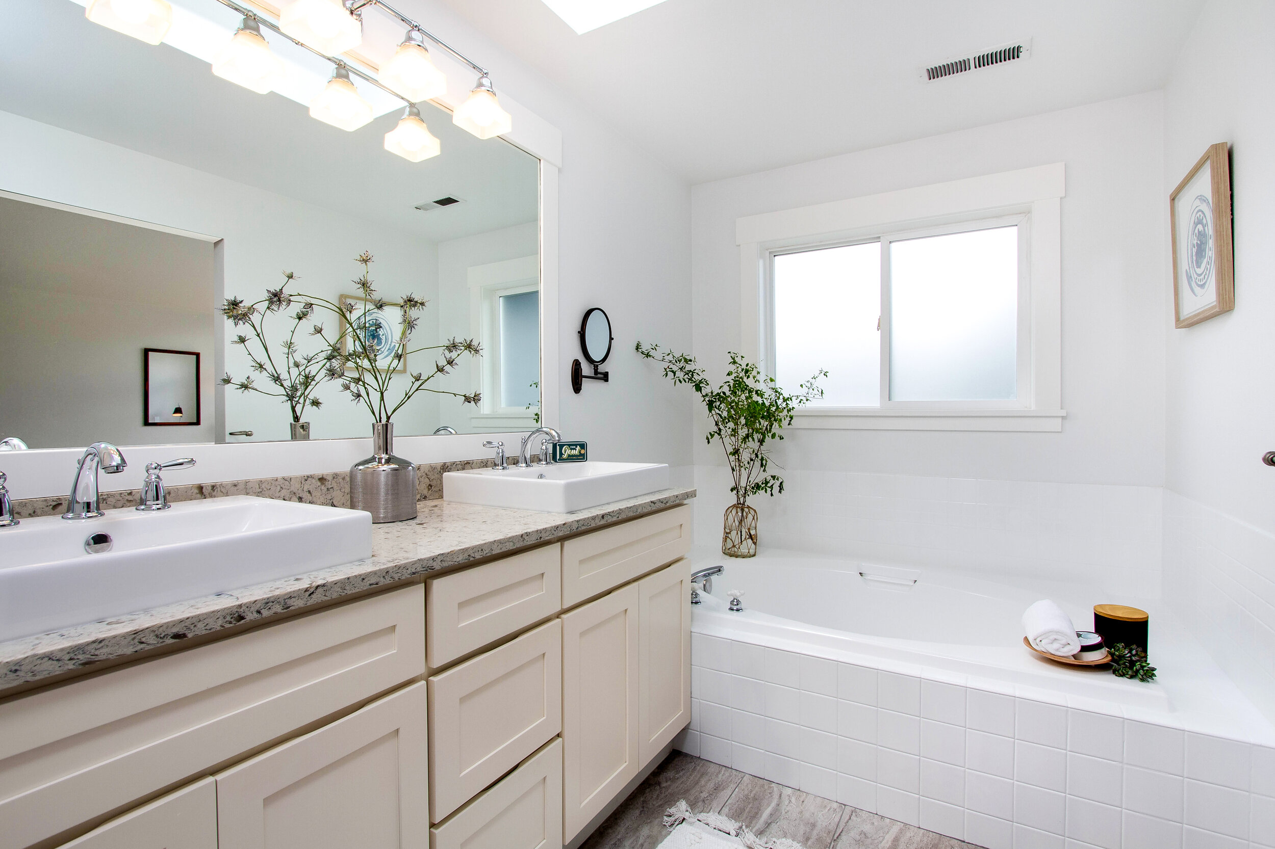  Refresh in the master bath, equipped with dual sinks, a soaking tub, and a standing shower. 