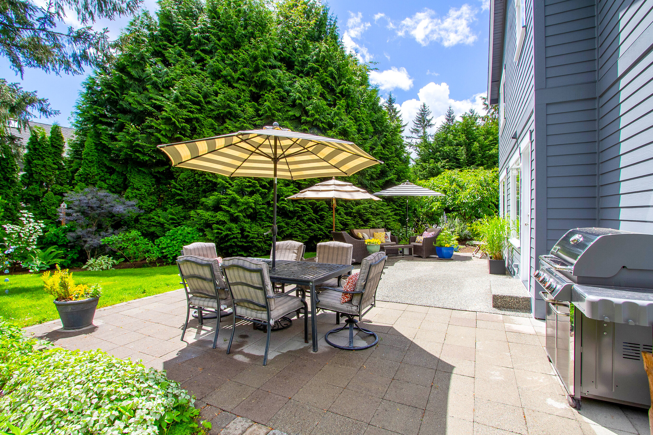  The exquisite backyard boasts everything you could ask for with a sun-filled patio, space for lounging, grilling, and playing in the yard. 