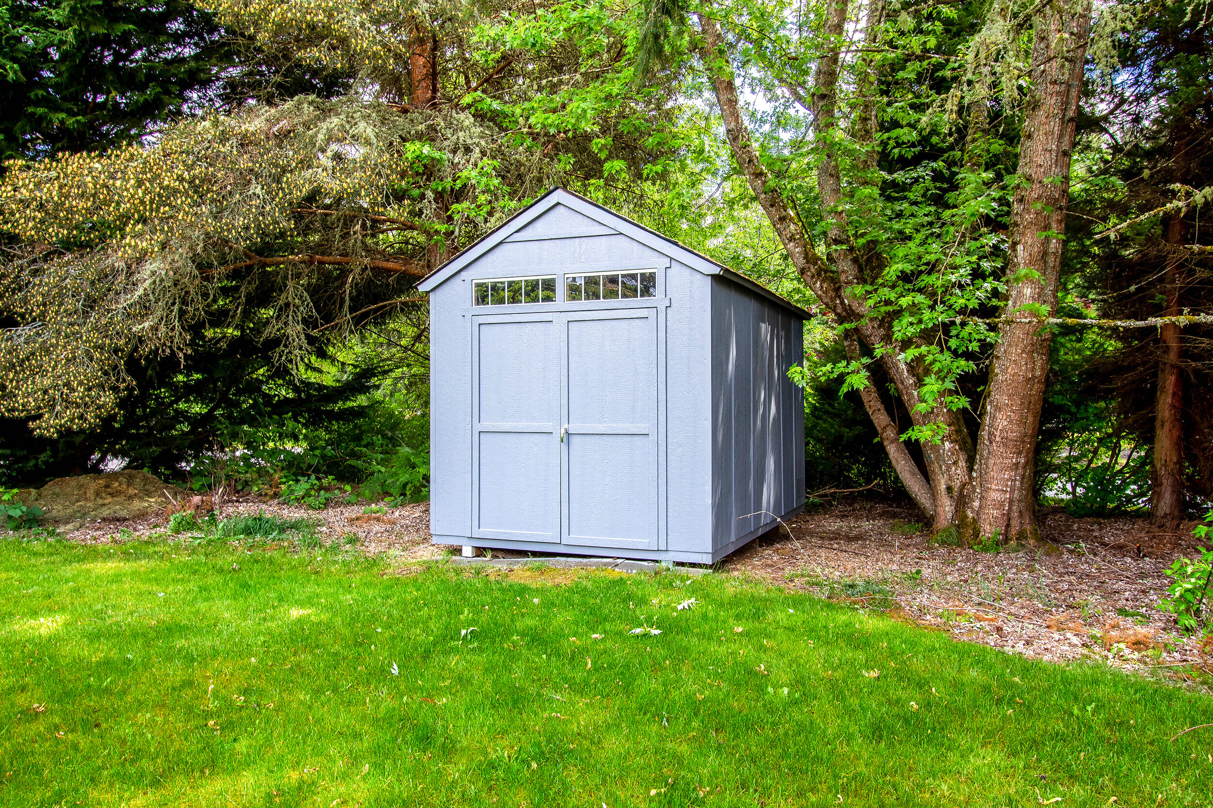  An additional shed boasts extra storage space in addition to the two-car garage. 