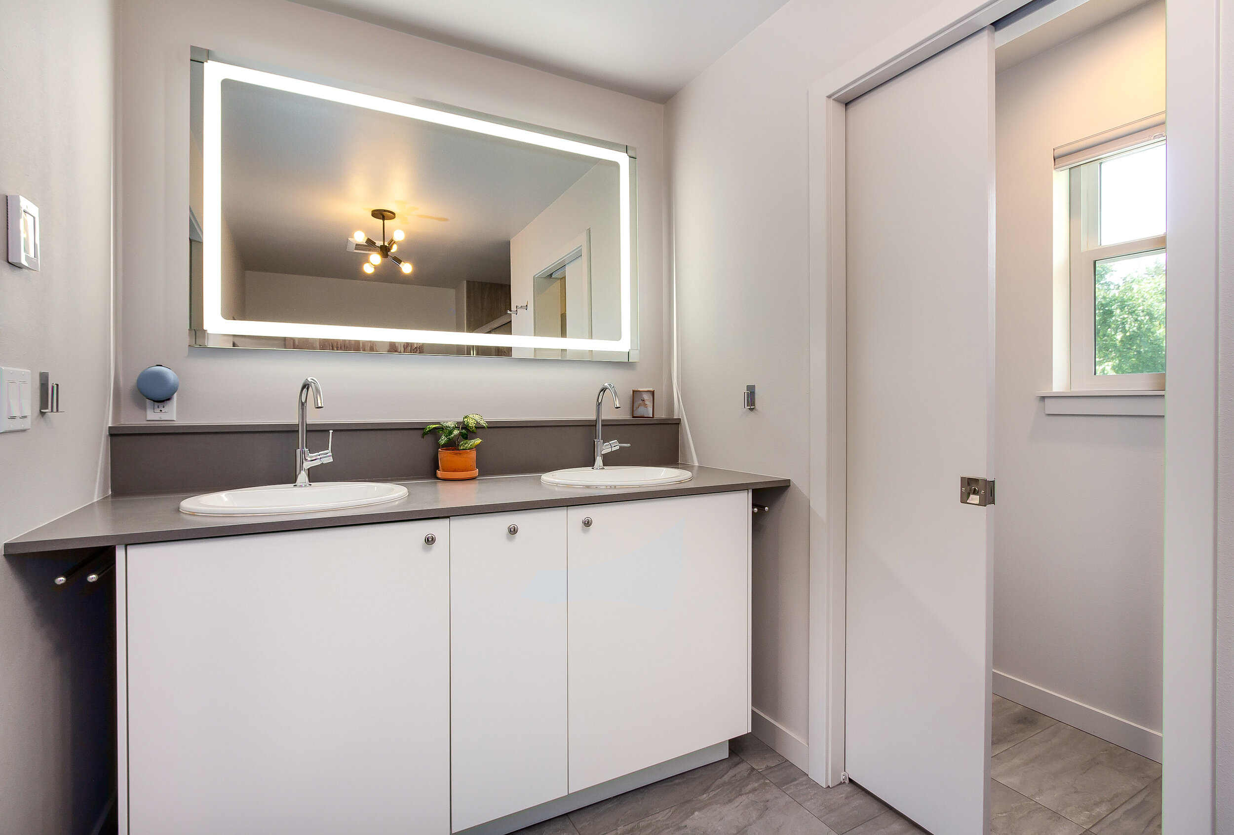 Dual sinks and a lighted mirror are just a few of the sophisticated touches that complete the master bath.