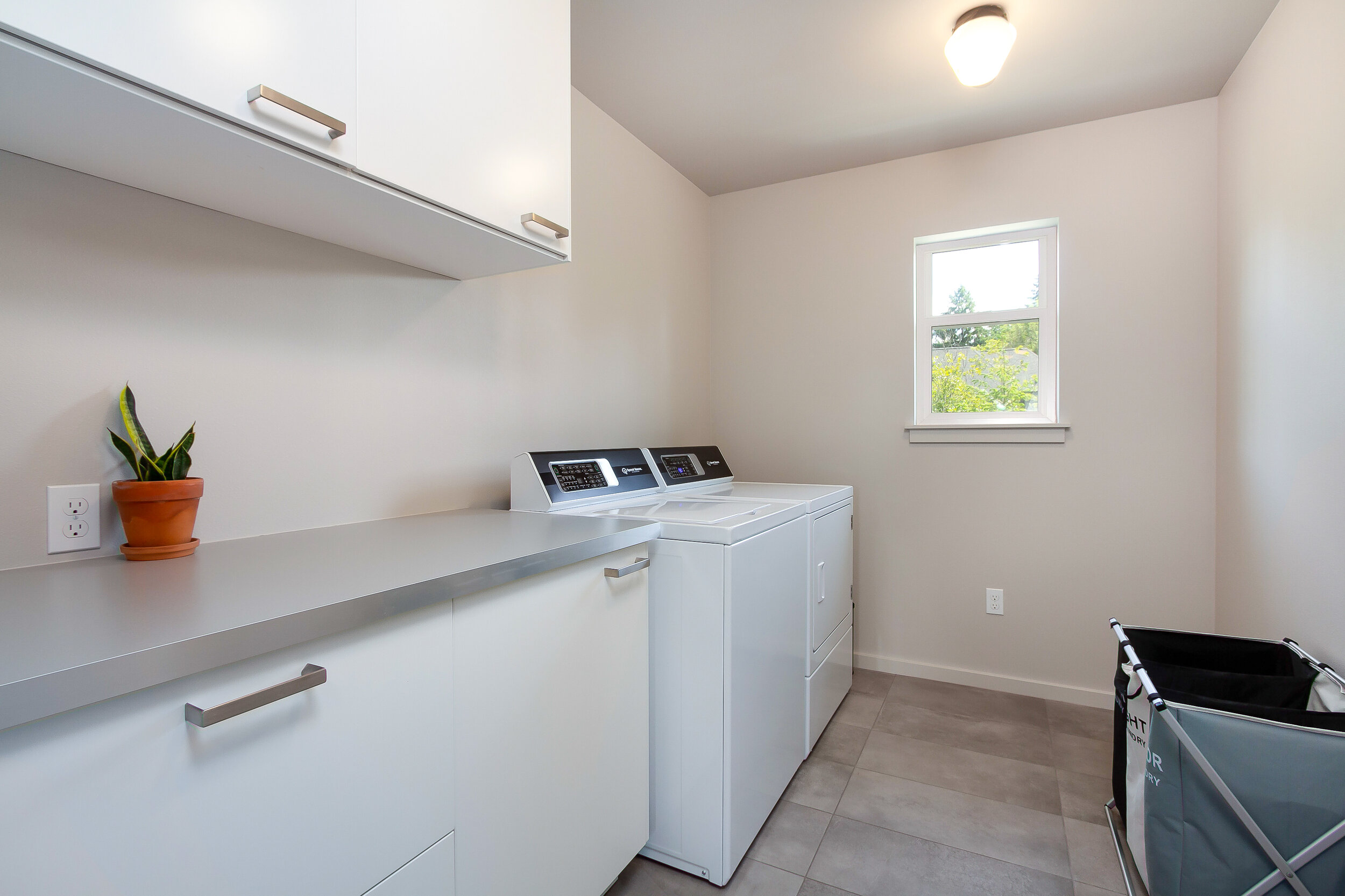 Laundry is a breeze in the generous laundry room, with ample counter space for folding and sorting. 