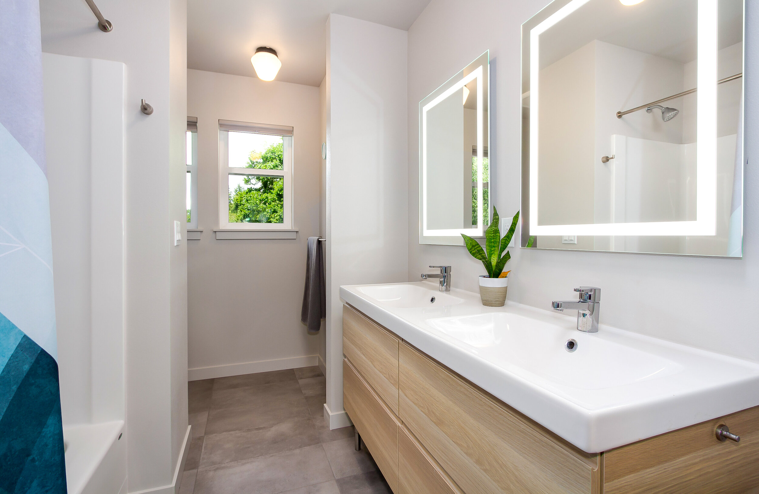 Perfect for sharing, the additional bathroom on the second floor is also complete with dual sinks and lit mirrors. 