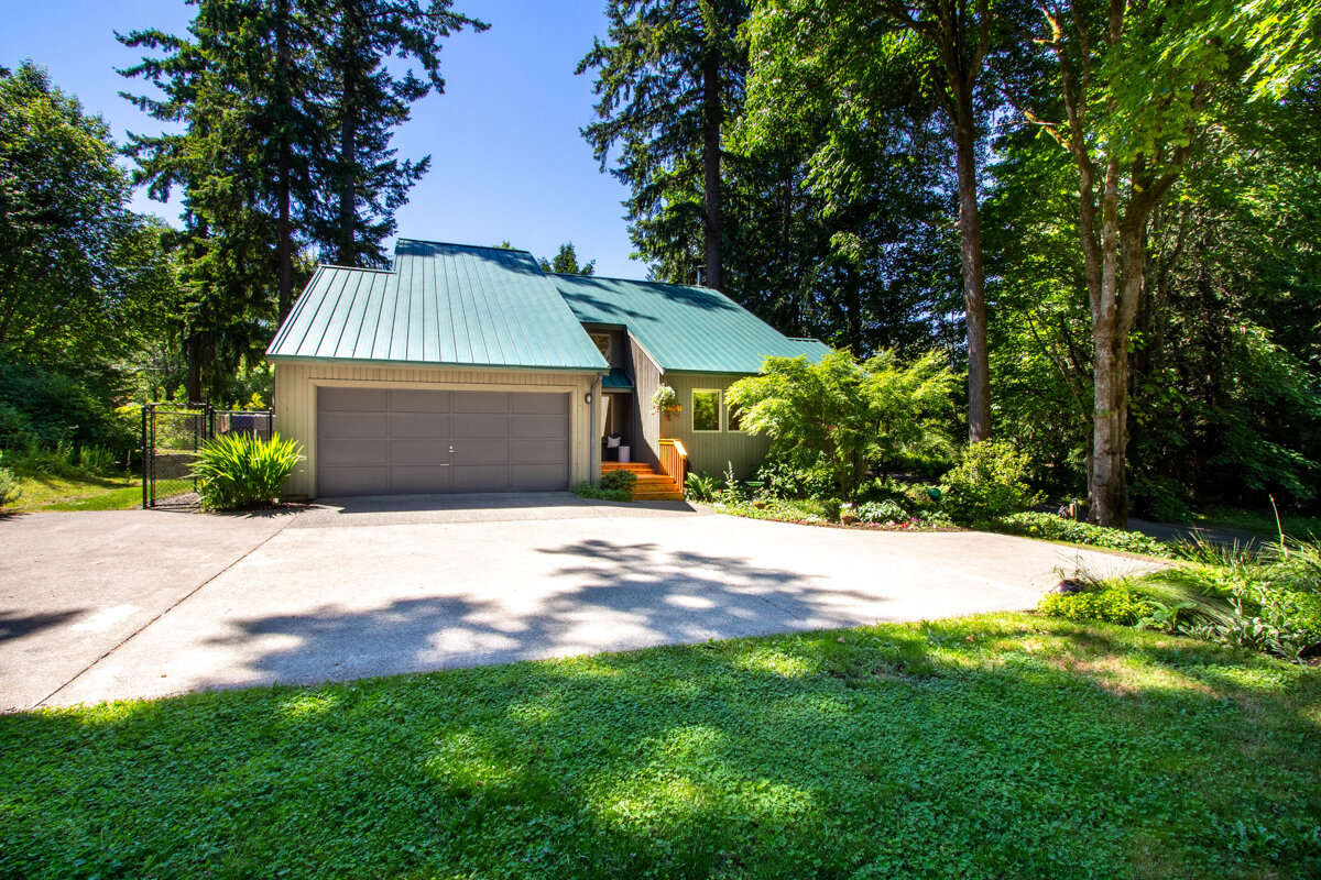 Tucked away amongst the trees, enjoy ample space and privacy on this half-acre lot. 