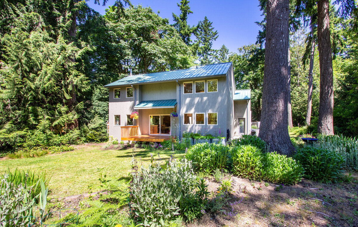 Tucked away amongst the trees, enjoy ample space and privacy on this half-acre lot. 