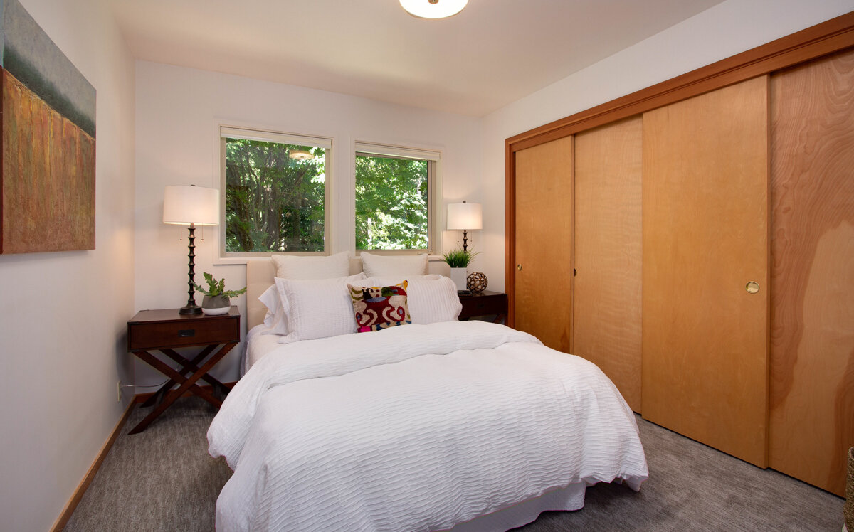 Three additional spare bedrooms with generous closets offer space for guests or family. 