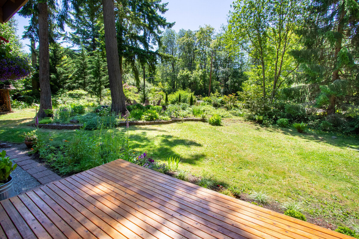 Your serene outdoor oasis awaits off your back deck, where verdant nature wraps around you.
