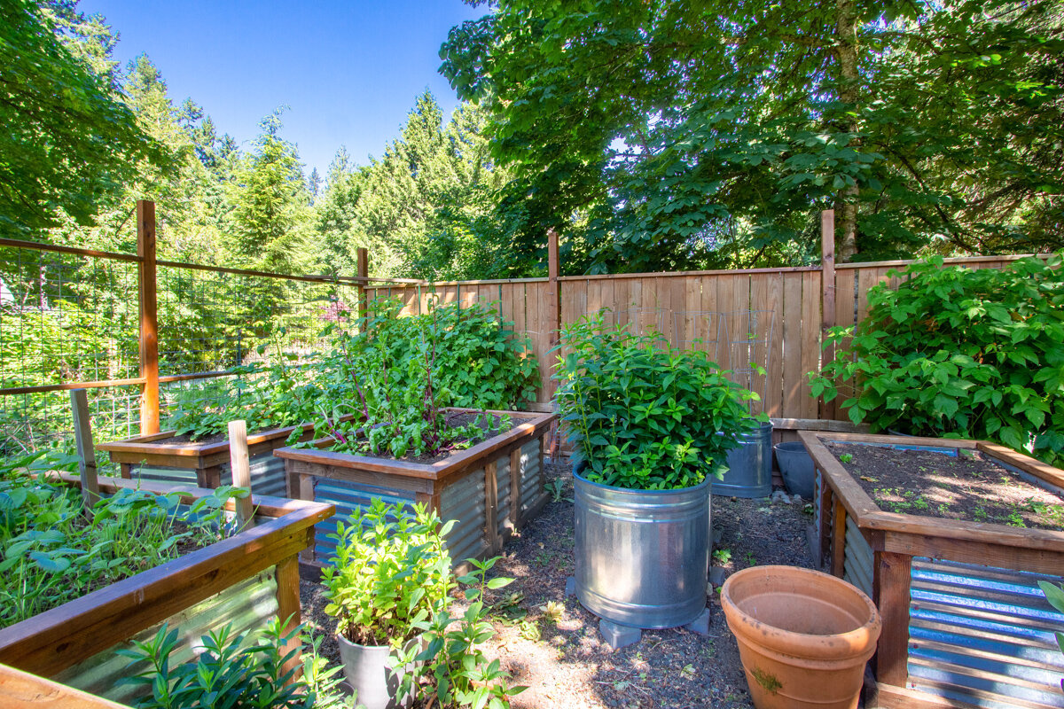 Cultivate the vegetable and herb garden of your dreams with this fenced-in area, complete with raised garden beds. 
