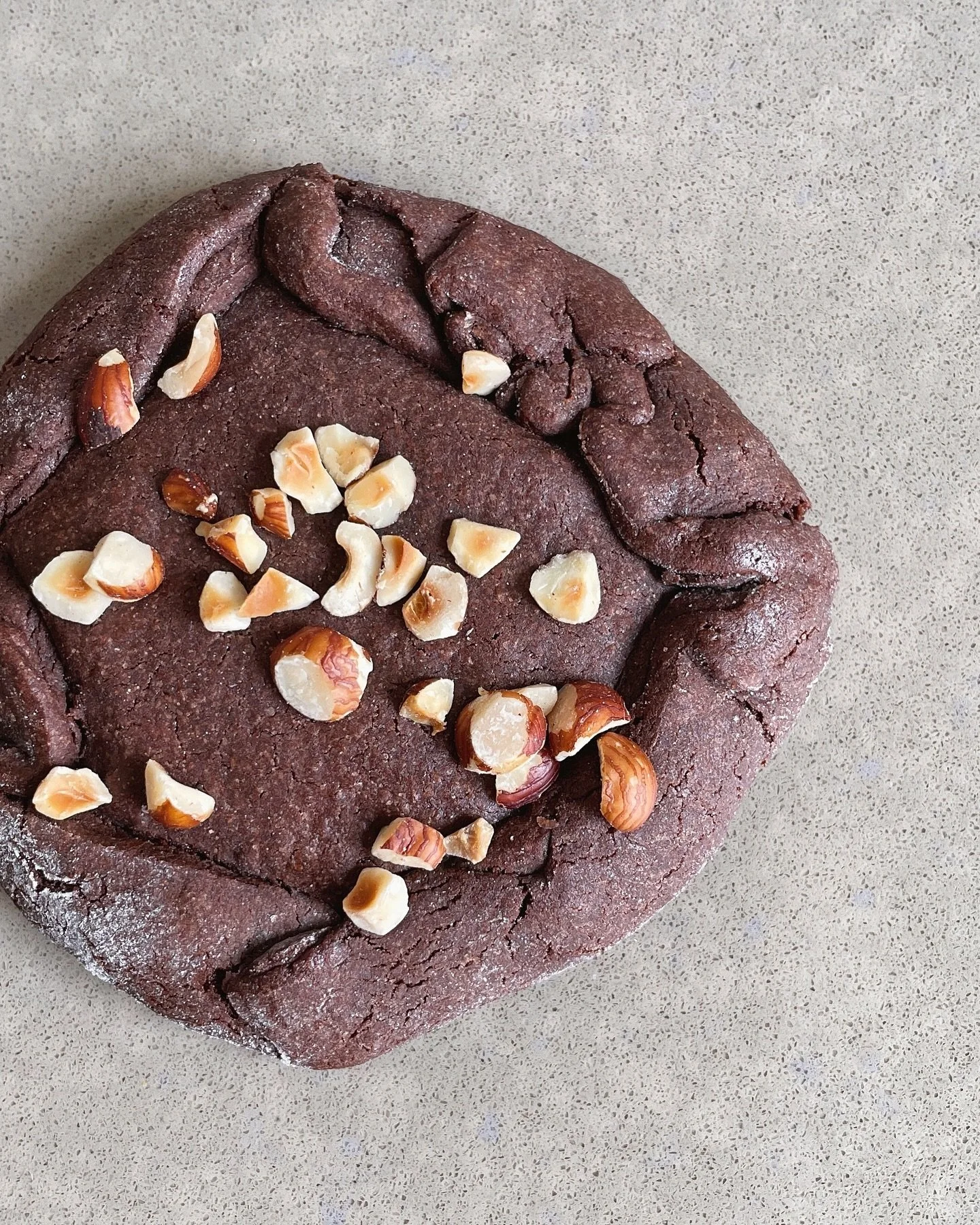 🤎 Nutellya Simonova 🤎
This indulgent chocolate cookie is stuffed with creamy nutella and topped with chopped hazelnuts. Named for Natalya Simonova, the computer programmer and Bond girl from the film Goldeneye. 

🌸 Available only in April! 

You c