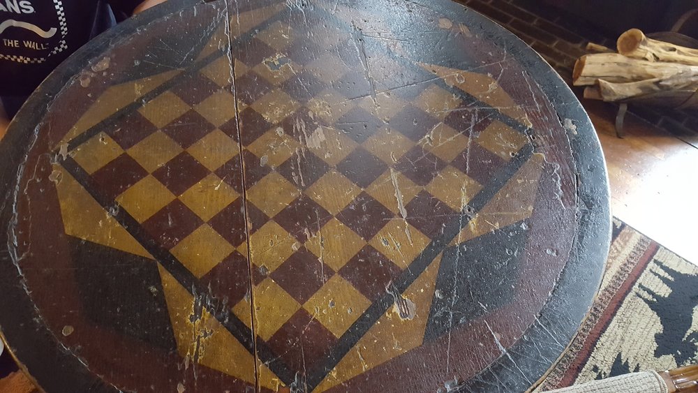 Antique checkerboard table in the men's tap room at Wolf Creek Inn