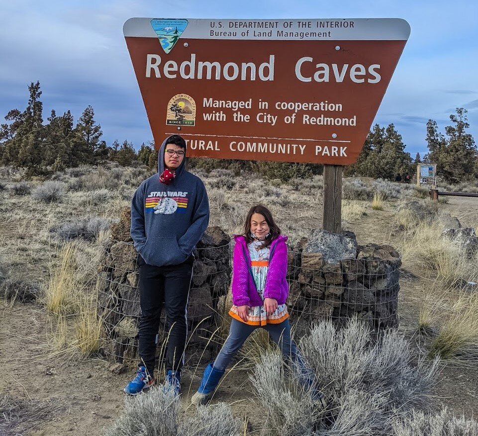 Redmond Caves - Kids in front of BLM sign.jpg