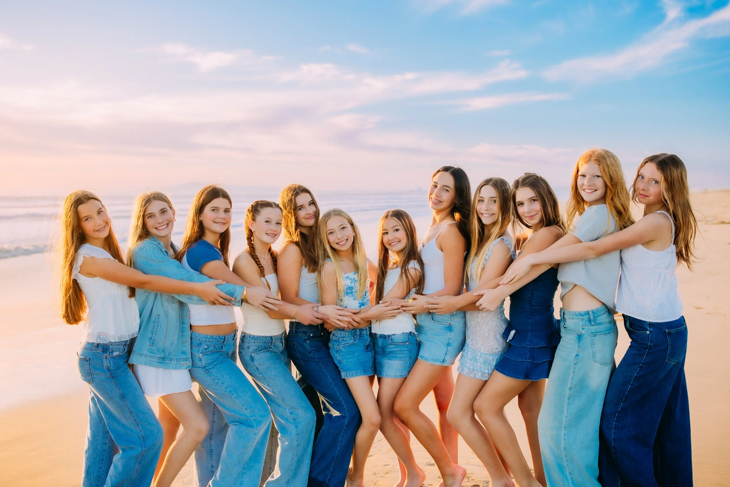 Group portrait of teenage girls on the beach in Orange County