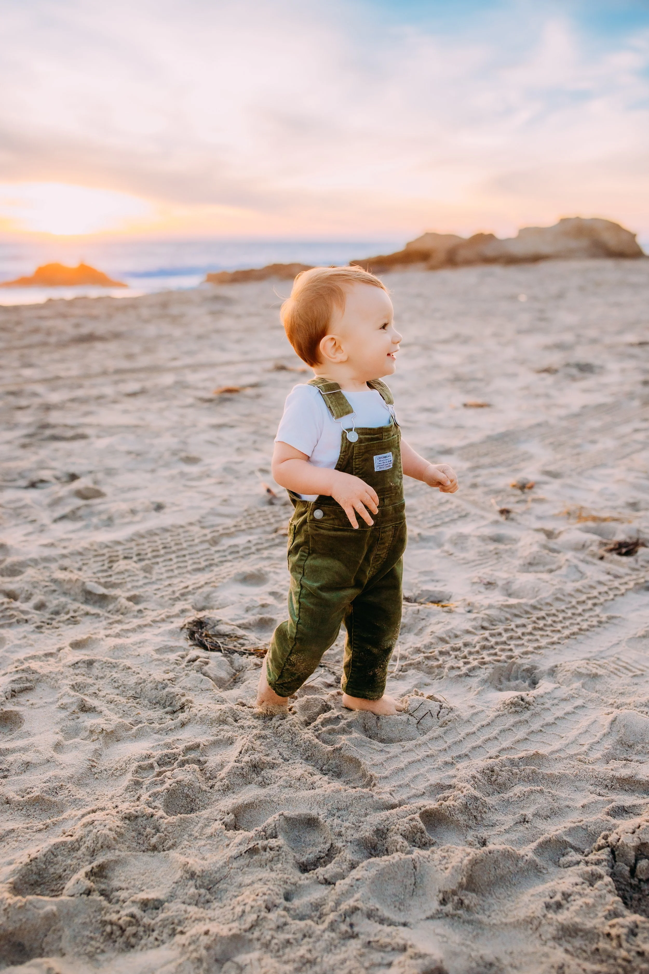 son walking along the beach during a mommy and me photoshoot in Newport Beach, CA.