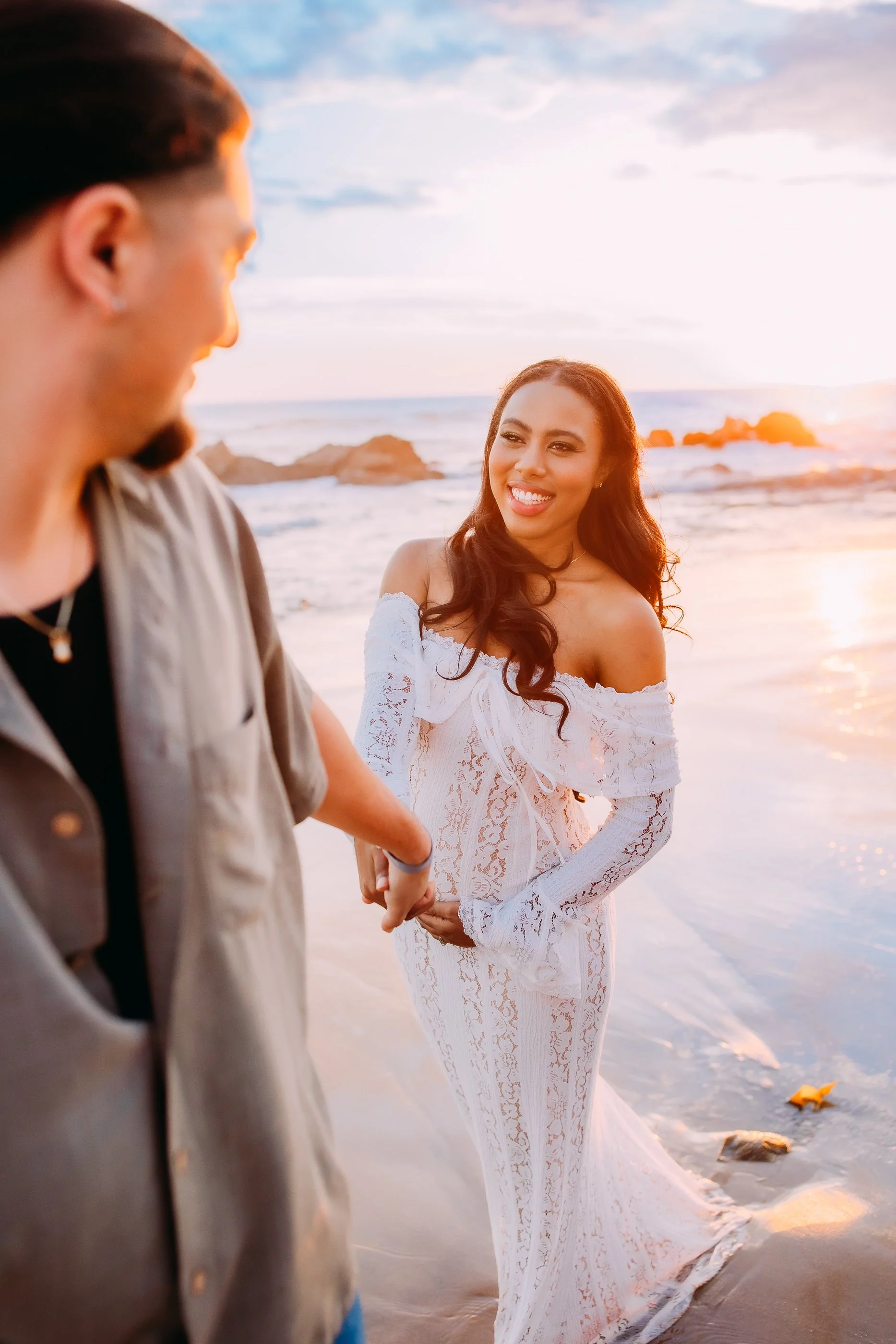 man taking his wife on a walk during their maternity photoshoot in Newport Beach, California
