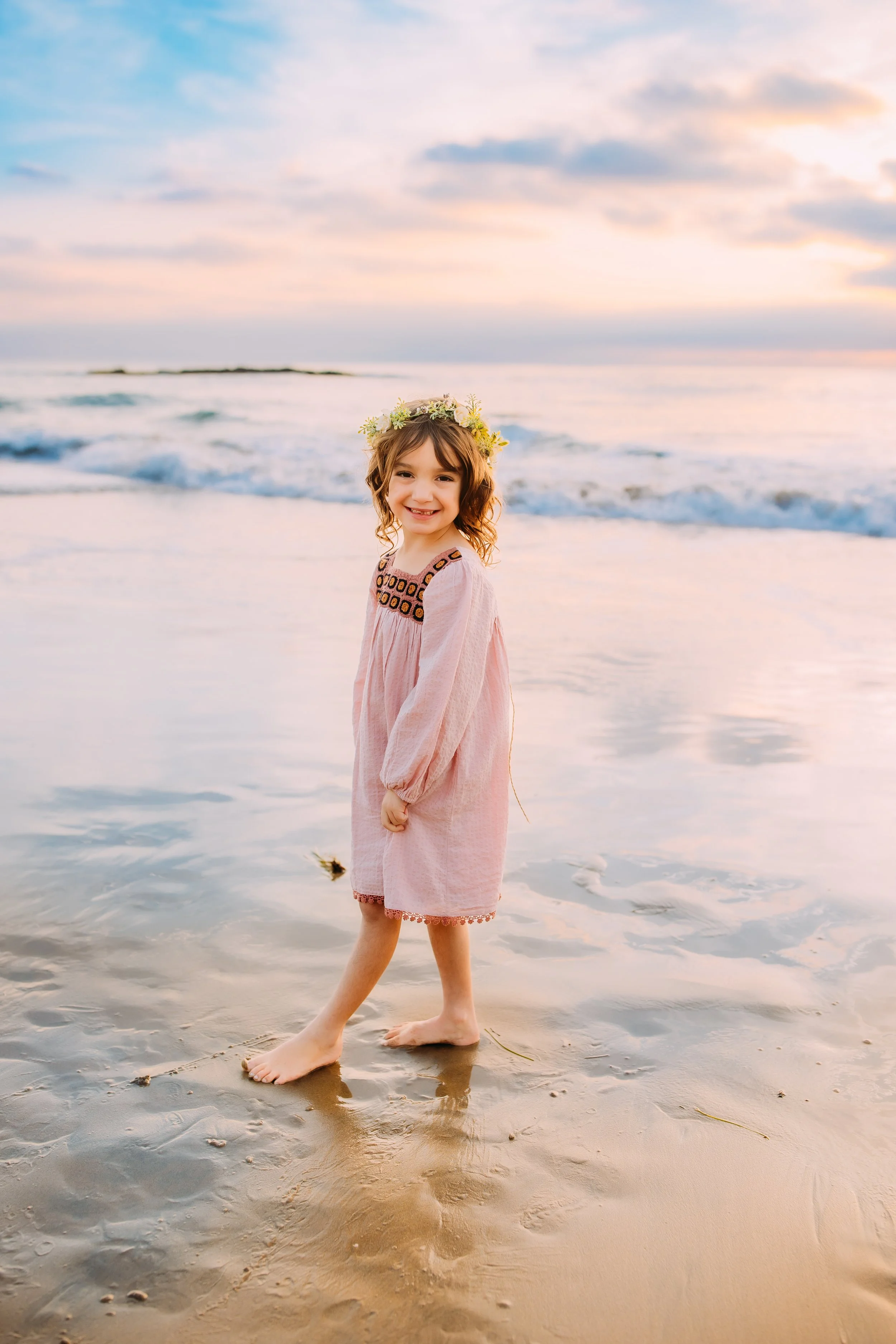 little girl posing during her family photo session in Newport Beach, CA