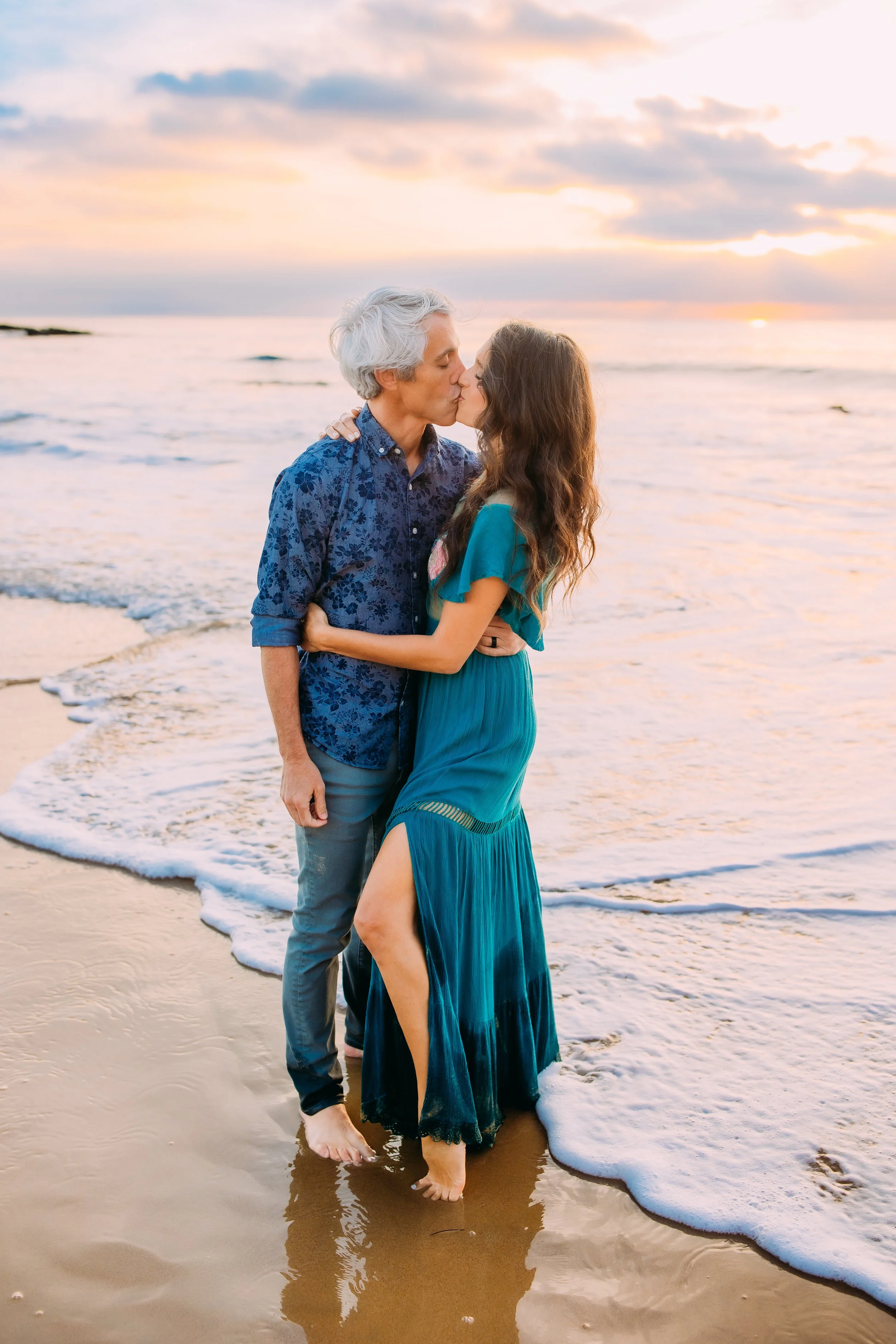 couple kissing on the beach at sunset during their photo session in Newport Beach, CA