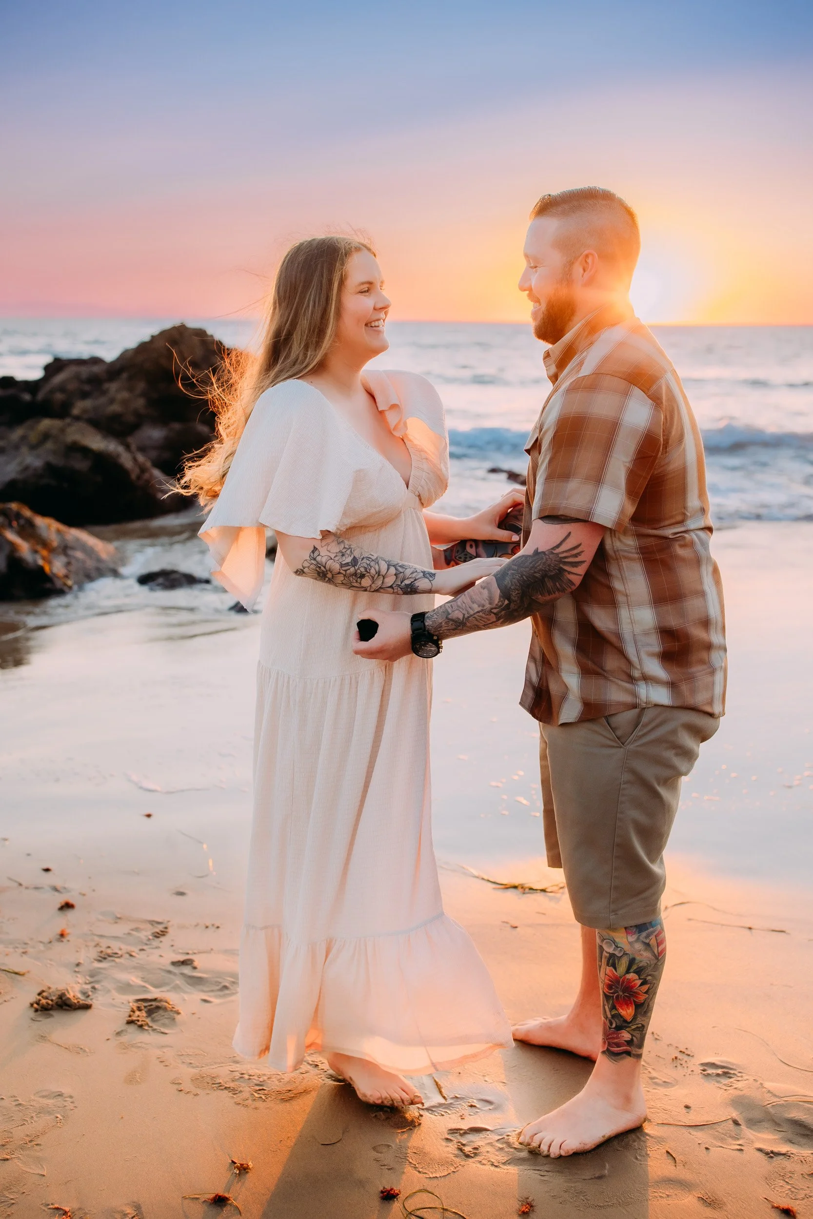 man doing a surprise proposal to his girlfriend during their photo shoot at sunset in Newport Beach, CA
