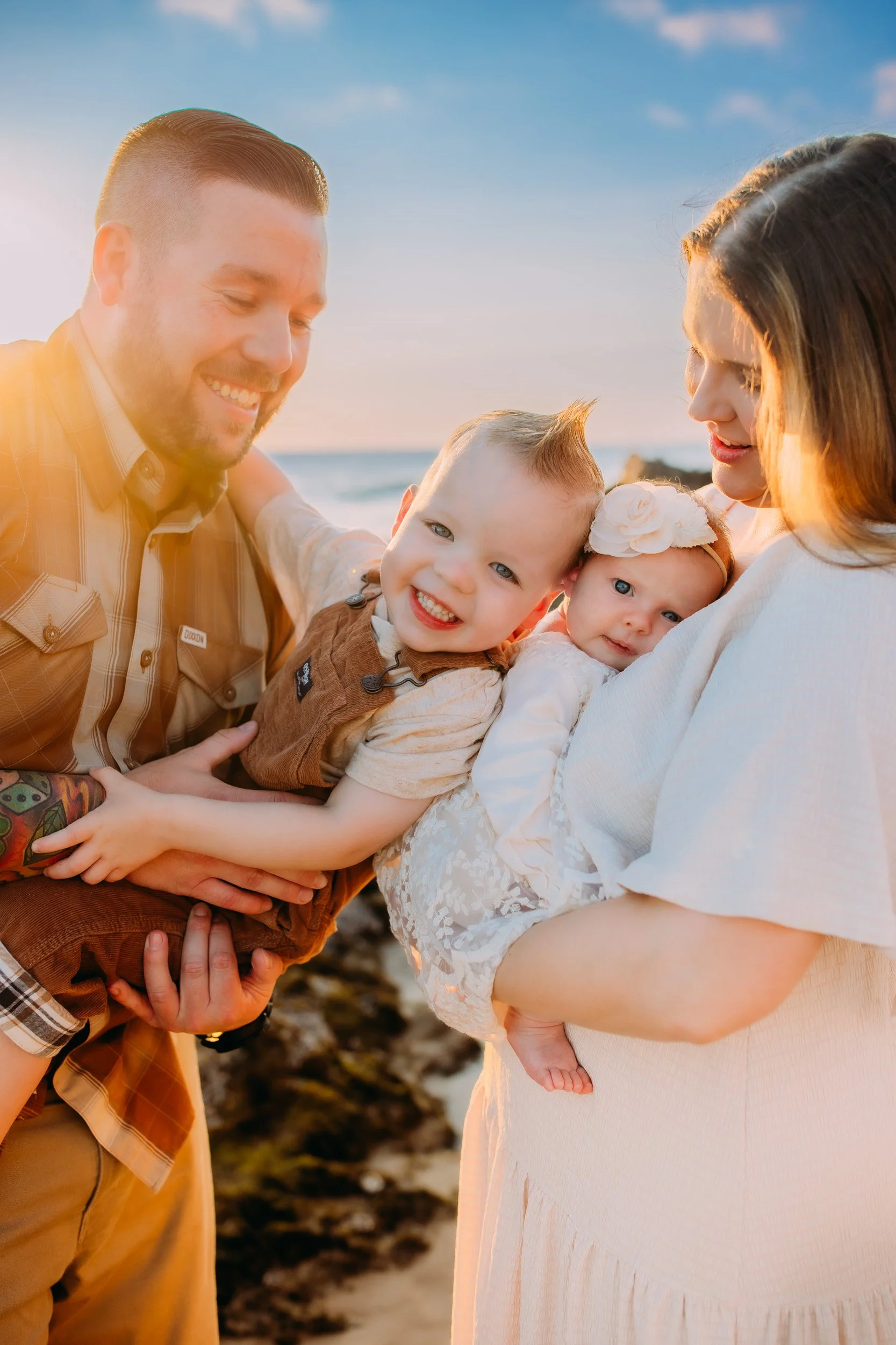 family all playing together at their family beach photoshoot in Newport Beach, CA