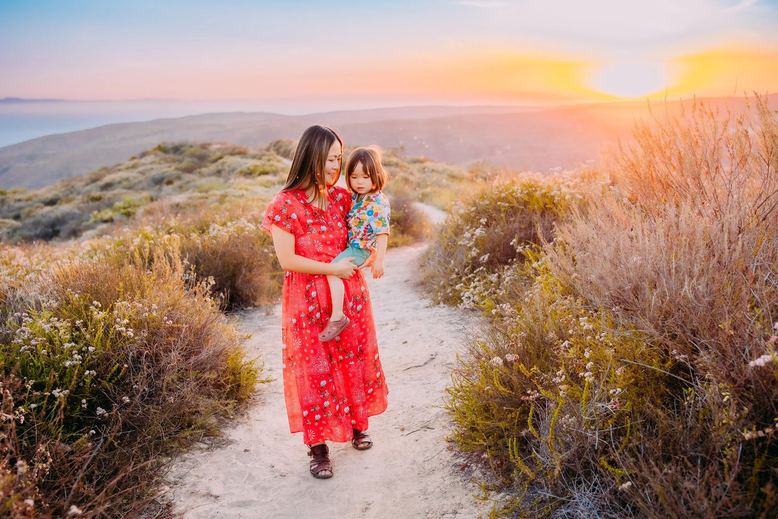 mother and son going for a walk during their lifestyle family photoshoot in the foothills of Laguna Beach, California