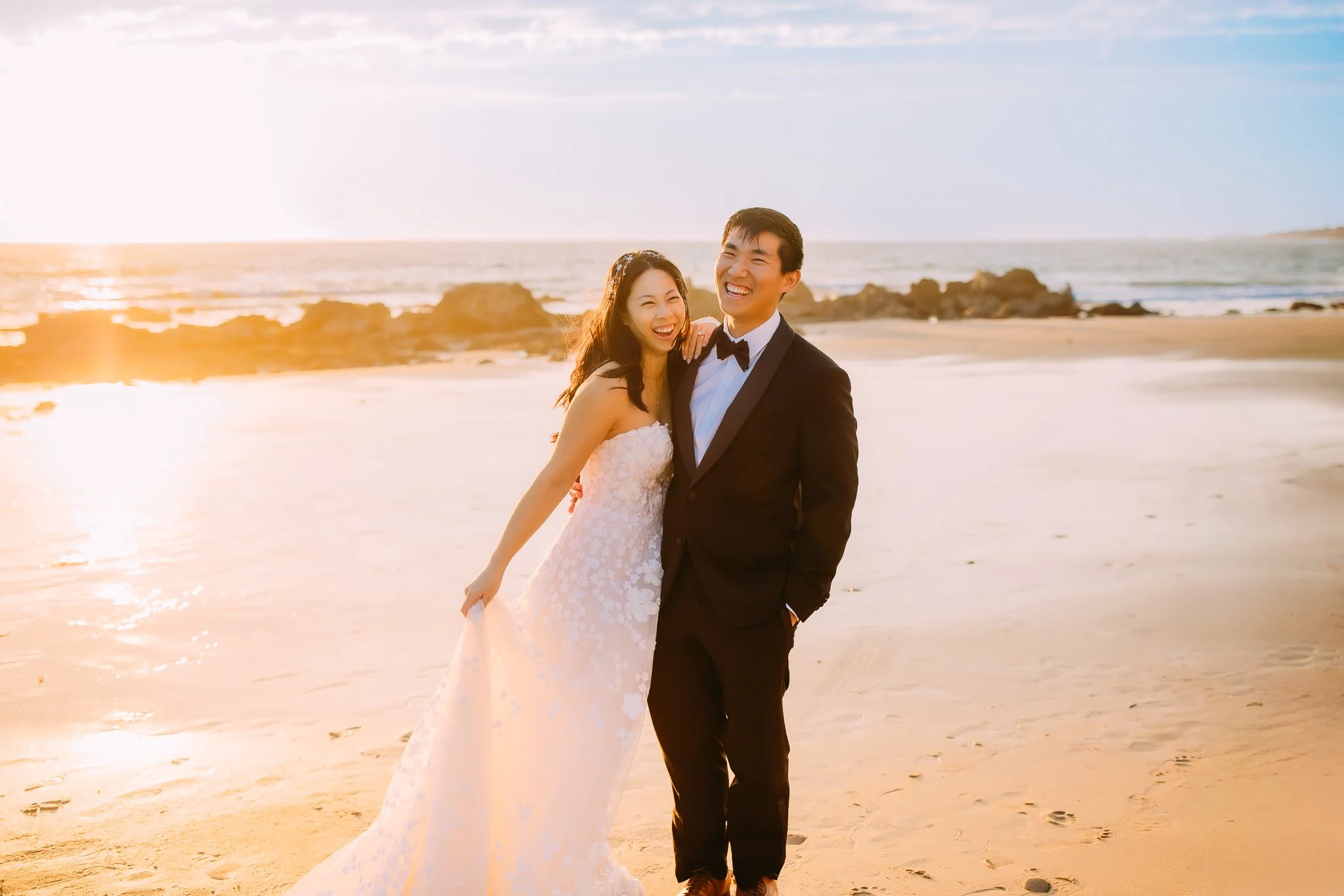 couple laughing during a candid moment during their bridal portraits in Newport Beach, CA