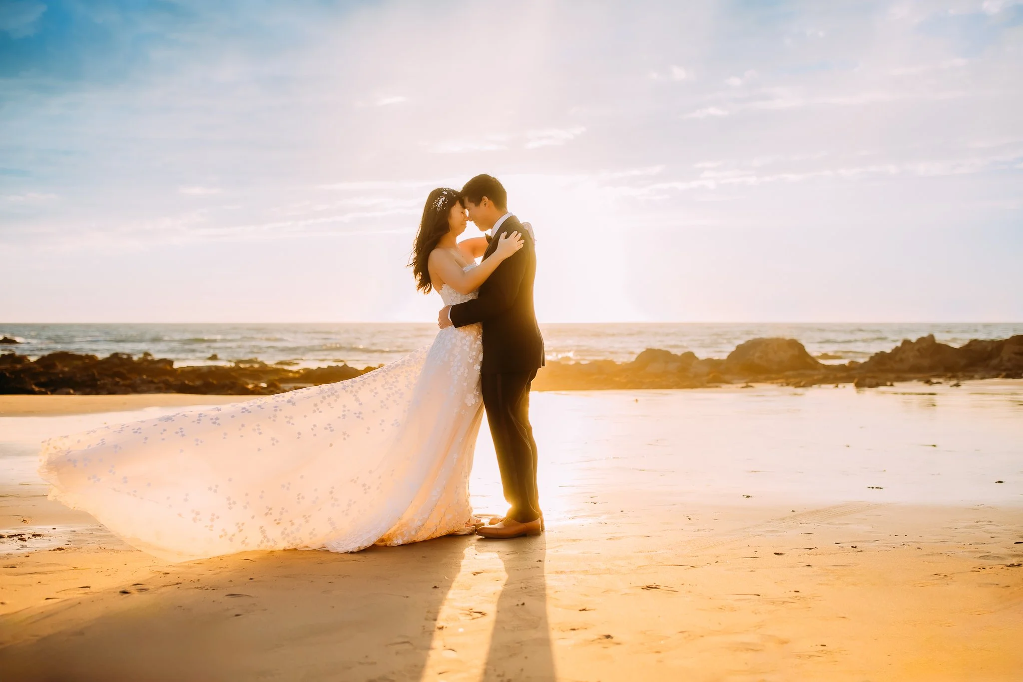 bridal portraits at sunset while wife's dress blows in the wind