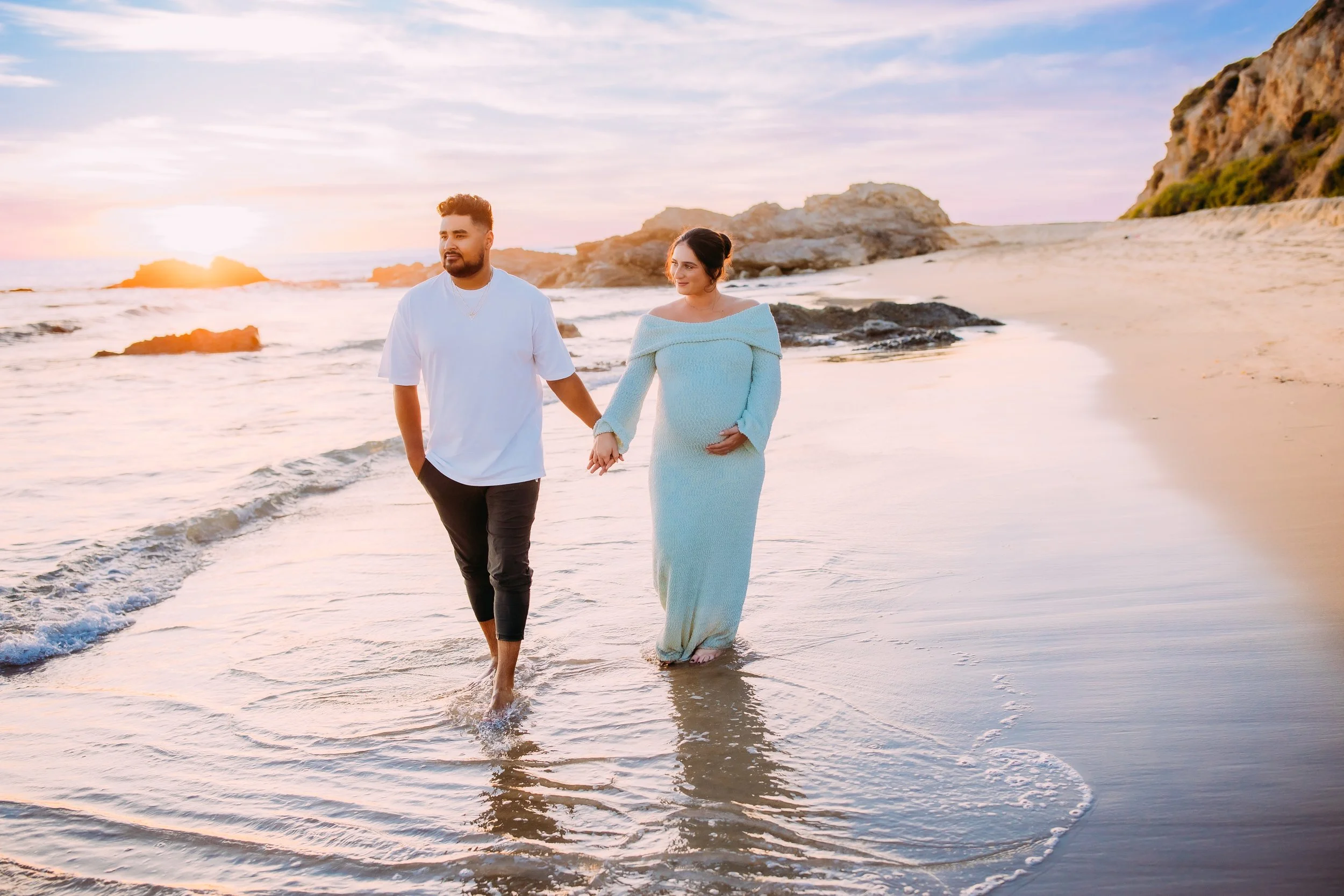 Maternity photos in Newport Beach at sunset with glowing mom and couple on beach