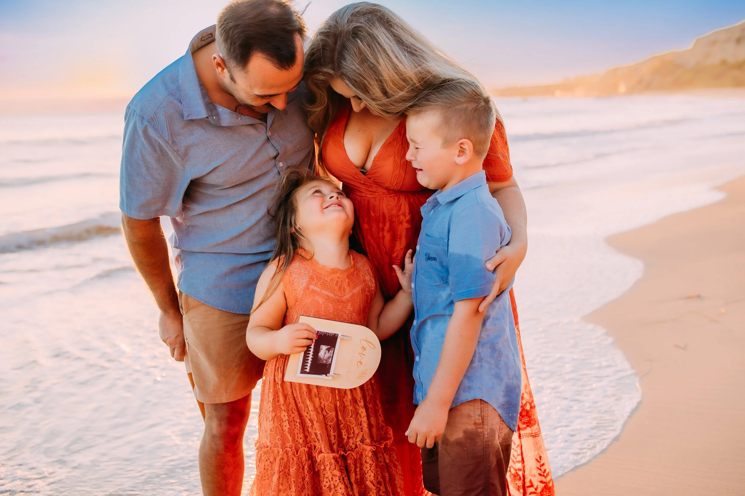 brother crying tears of joy during their family photos where siblings find out about the new baby announcement in Newport Beach, Orange County, California