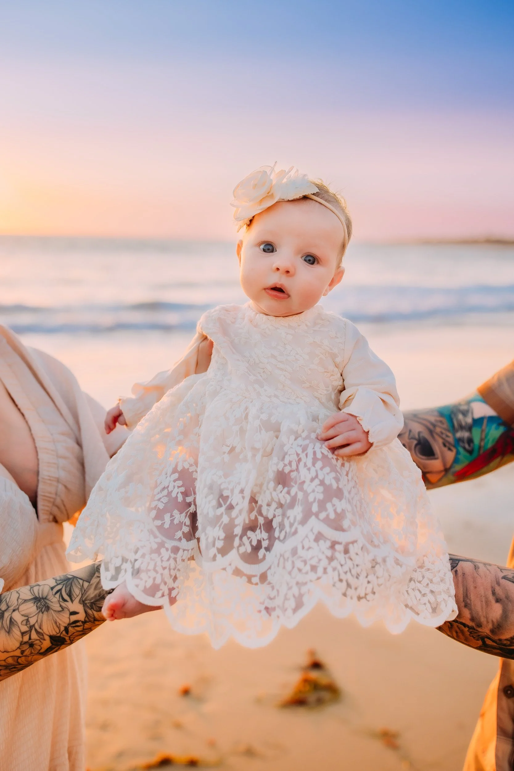 Newport Beach family session with one month old baby looking into the camera at sunset