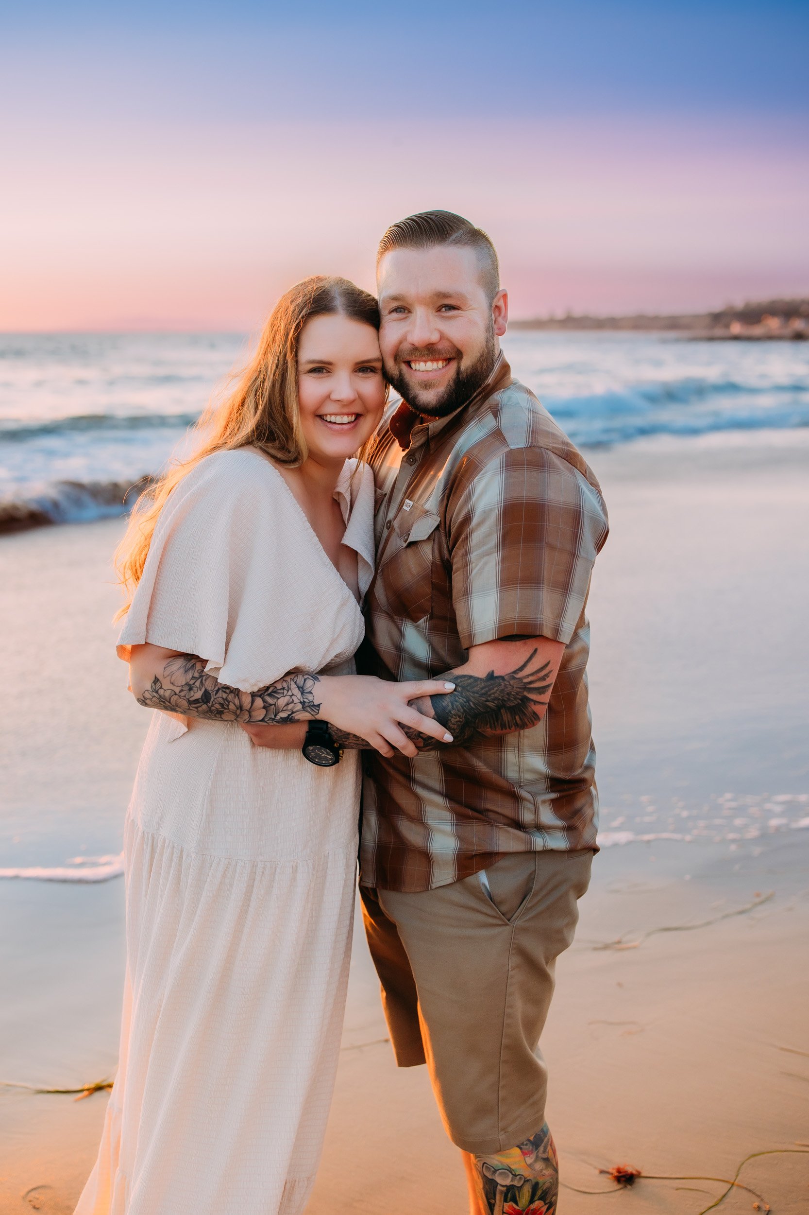 man doing a surprise proposal to his girlfriend during their photo shoot at sunset in Newport Beach, CA