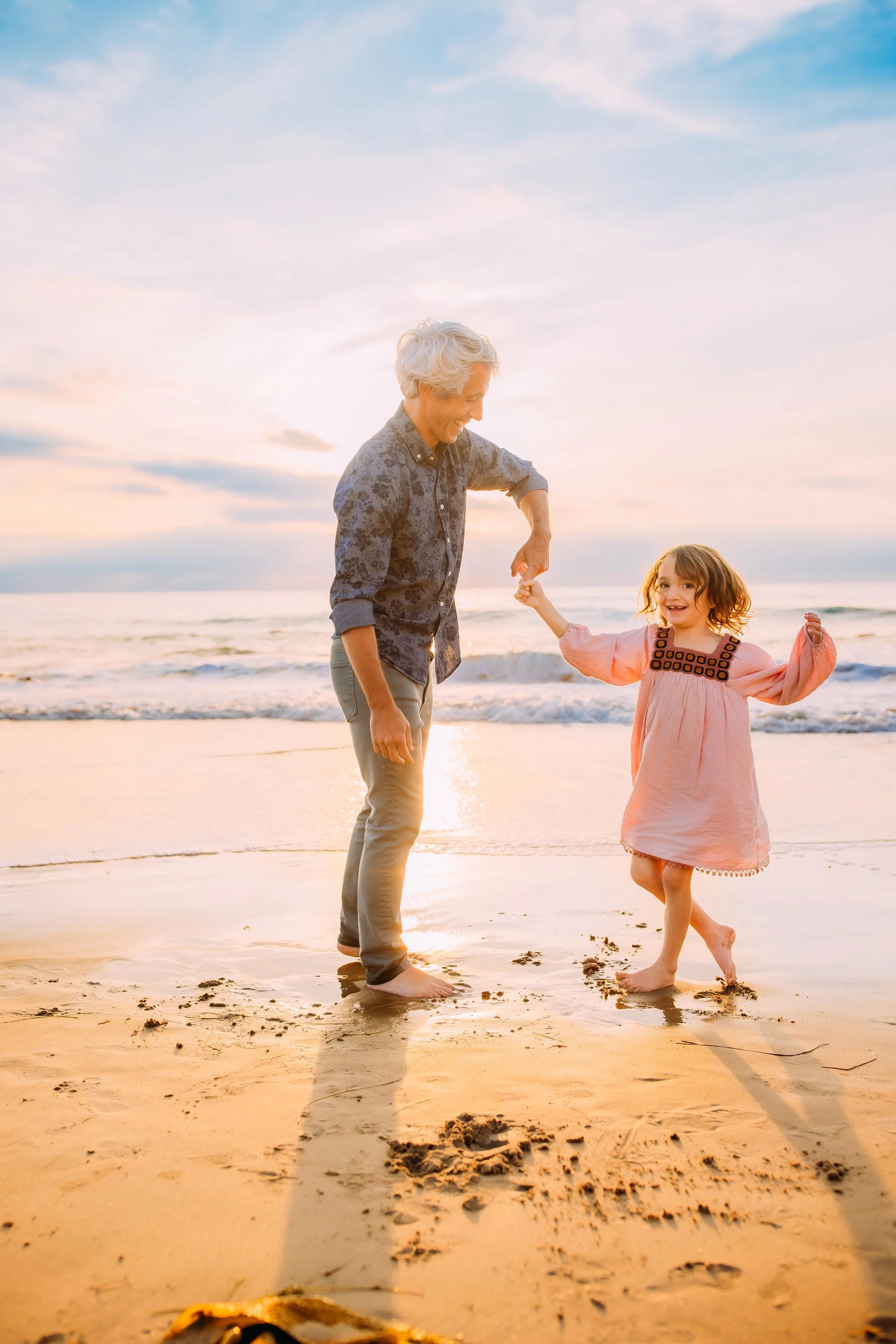 dad happily dancing his daughter during their family photos in Orange County, California