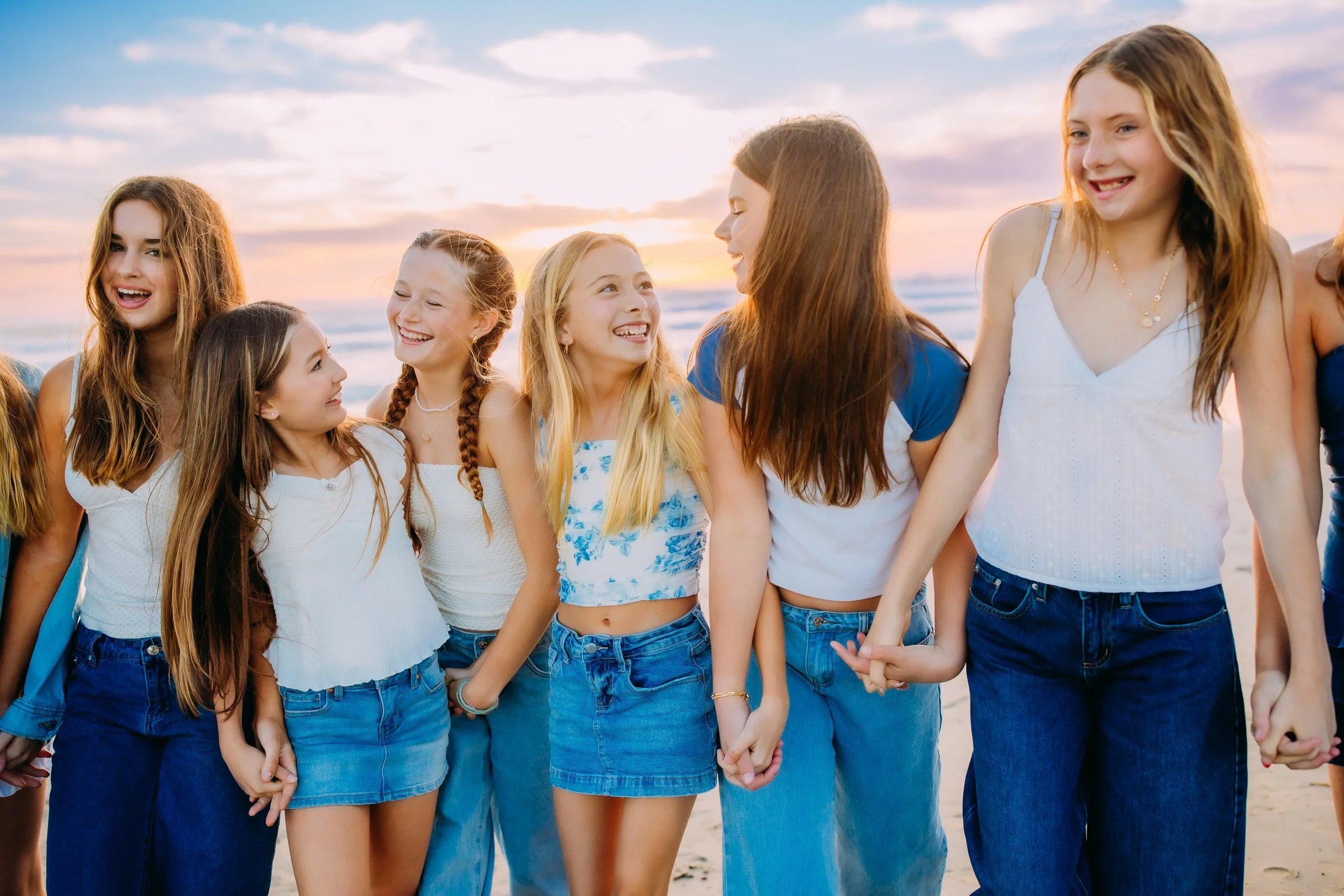 teenage friends walking along Newport Beach during a birthday photography session