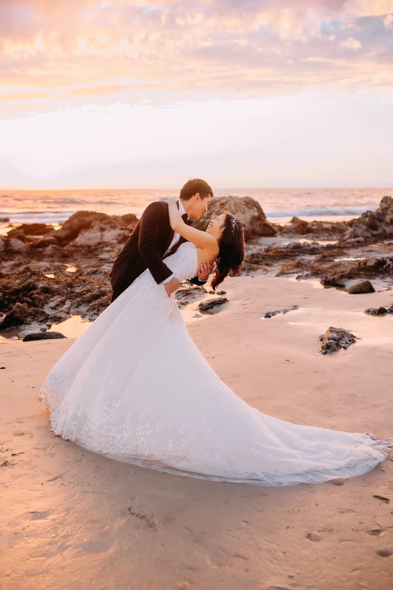 Sunset anniversary session while husband romantically dips his wife