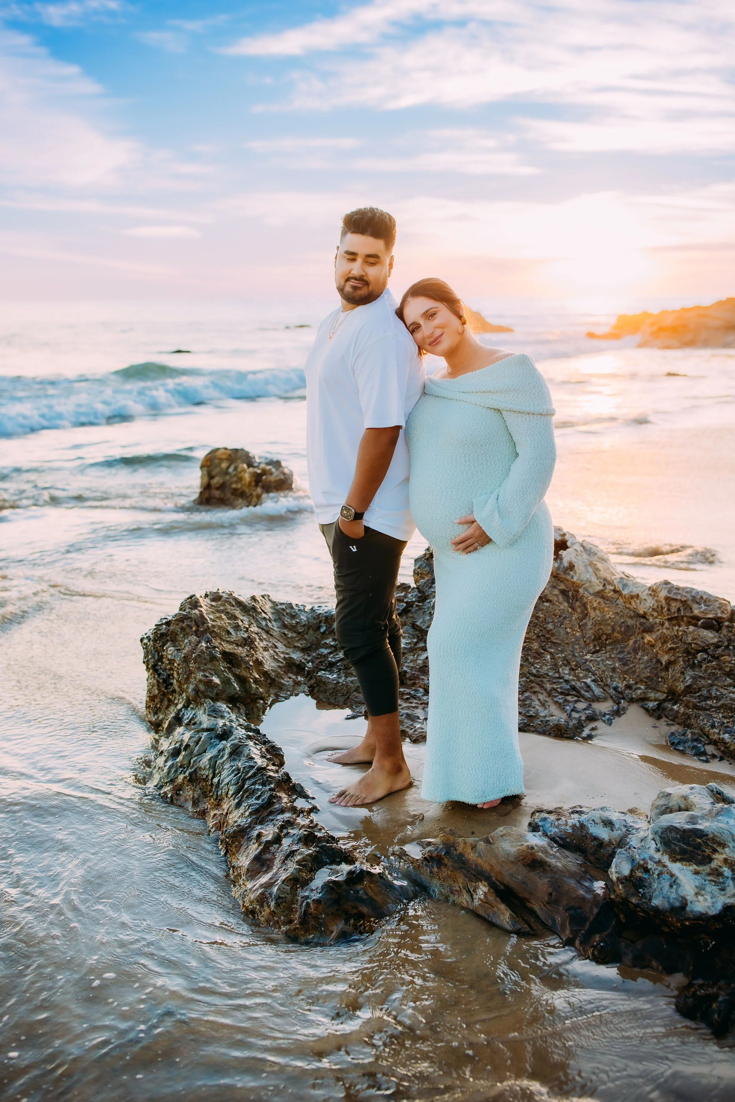 Maternity photos in Newport Beach at sunset with glowing mom and couple on beach