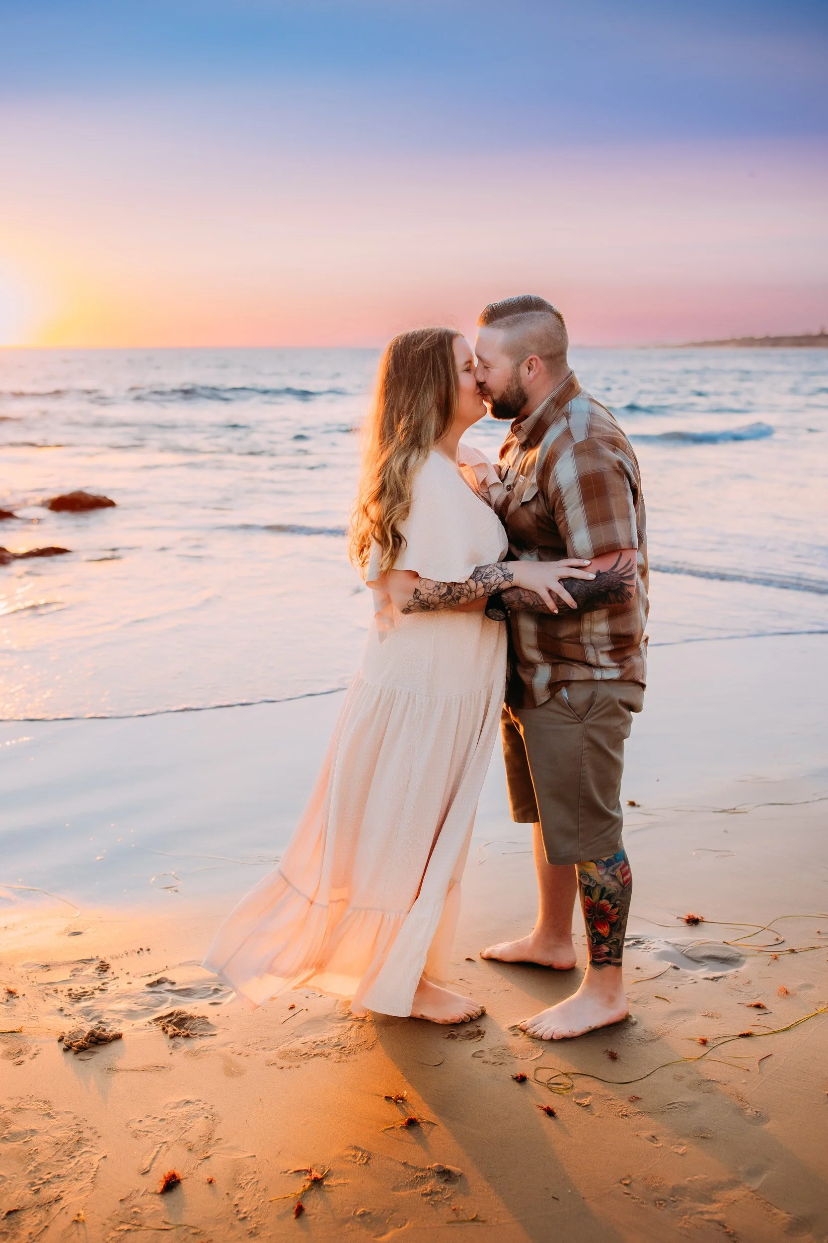 man doing a surprise proposal to his girlfriend during their photo shoot at sunset in Newport Beach, CA