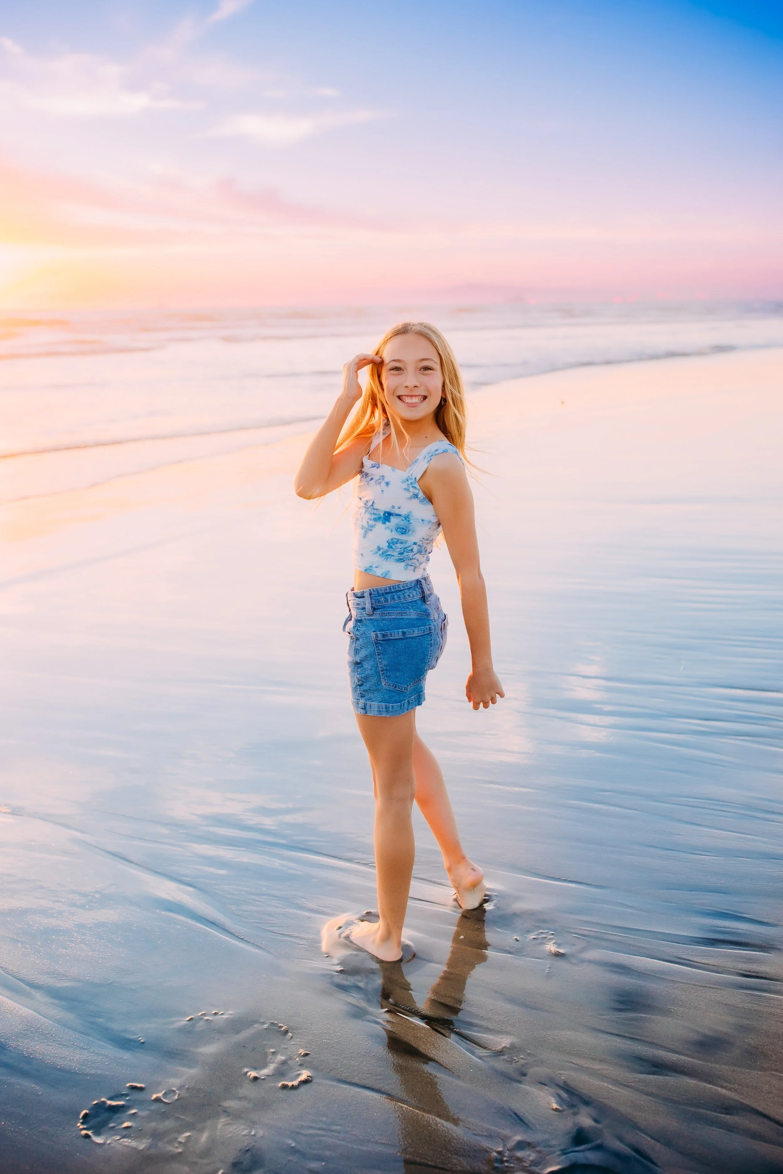 13-year-old birthday girl smiling during beach photoshoot in Orange County