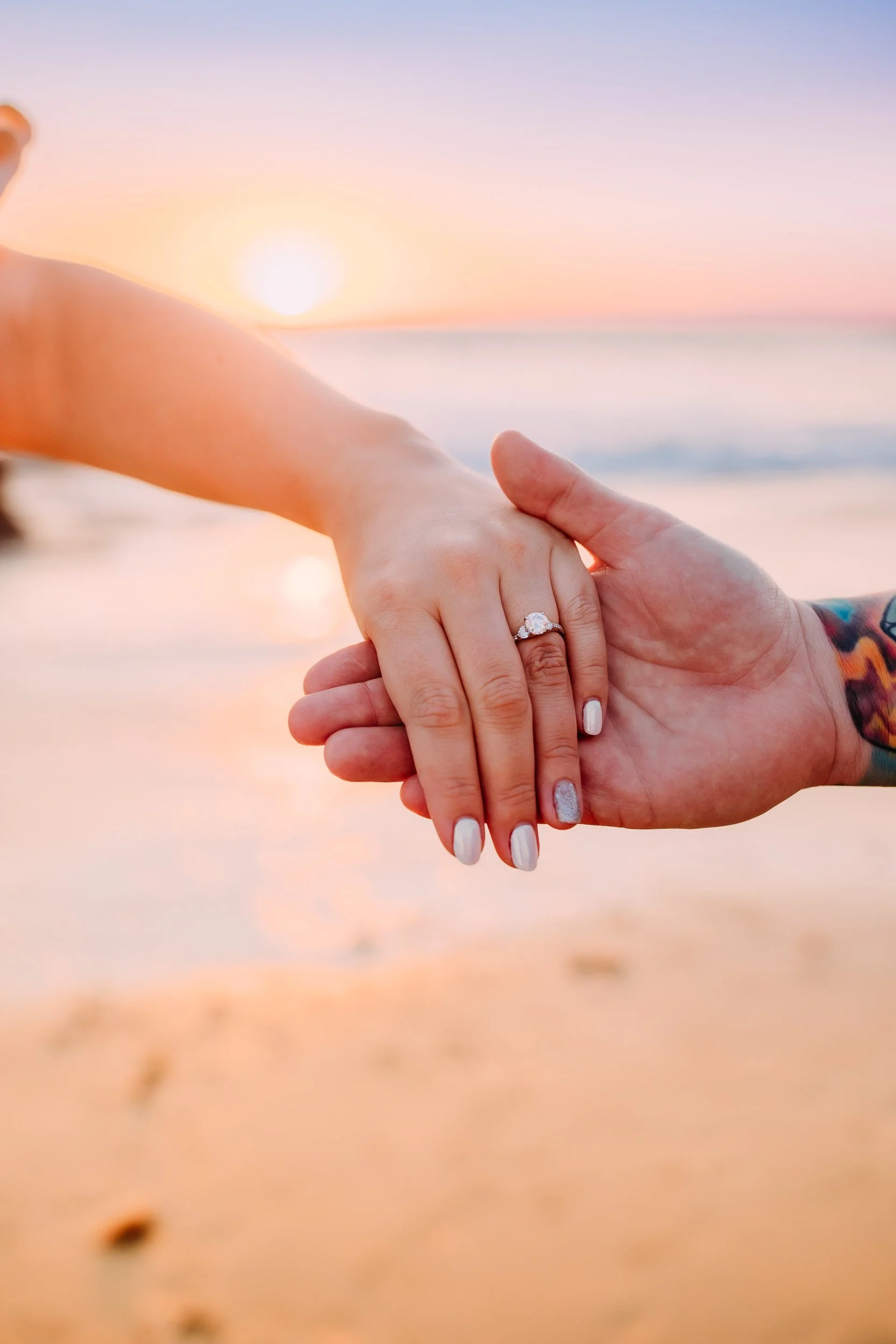 man doing a surprise proposal to his girlfriend during their photo shoot at sunset in Newport Beach, CA