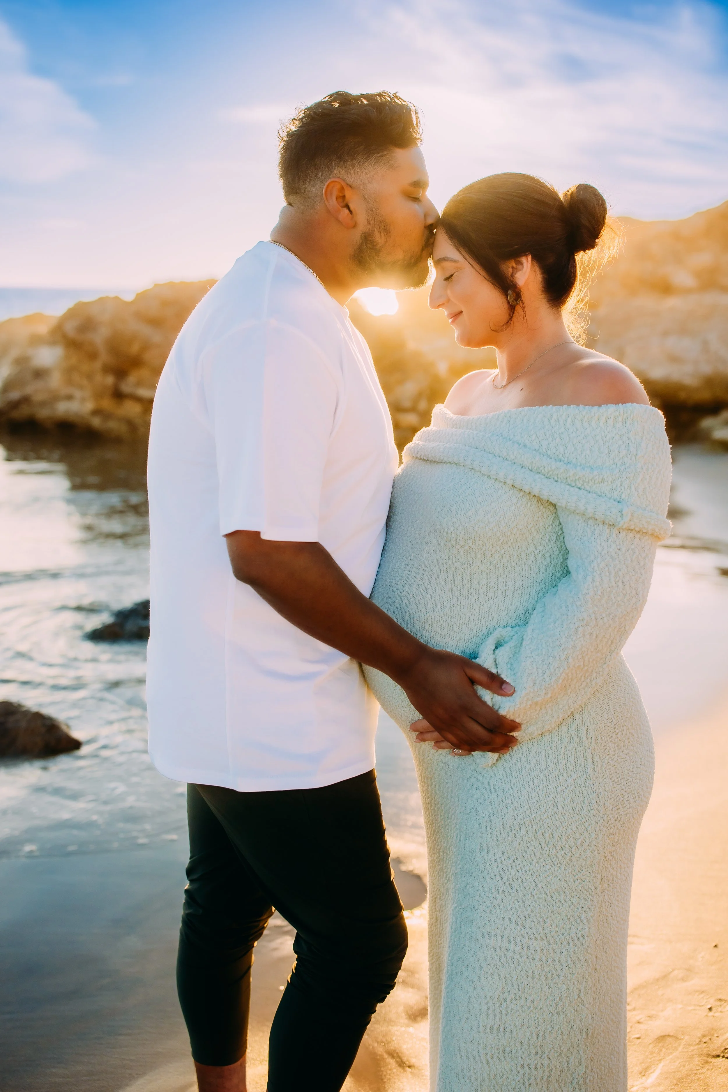 Maternity photos in Newport Beach at sunset with glowing mom and couple on beach