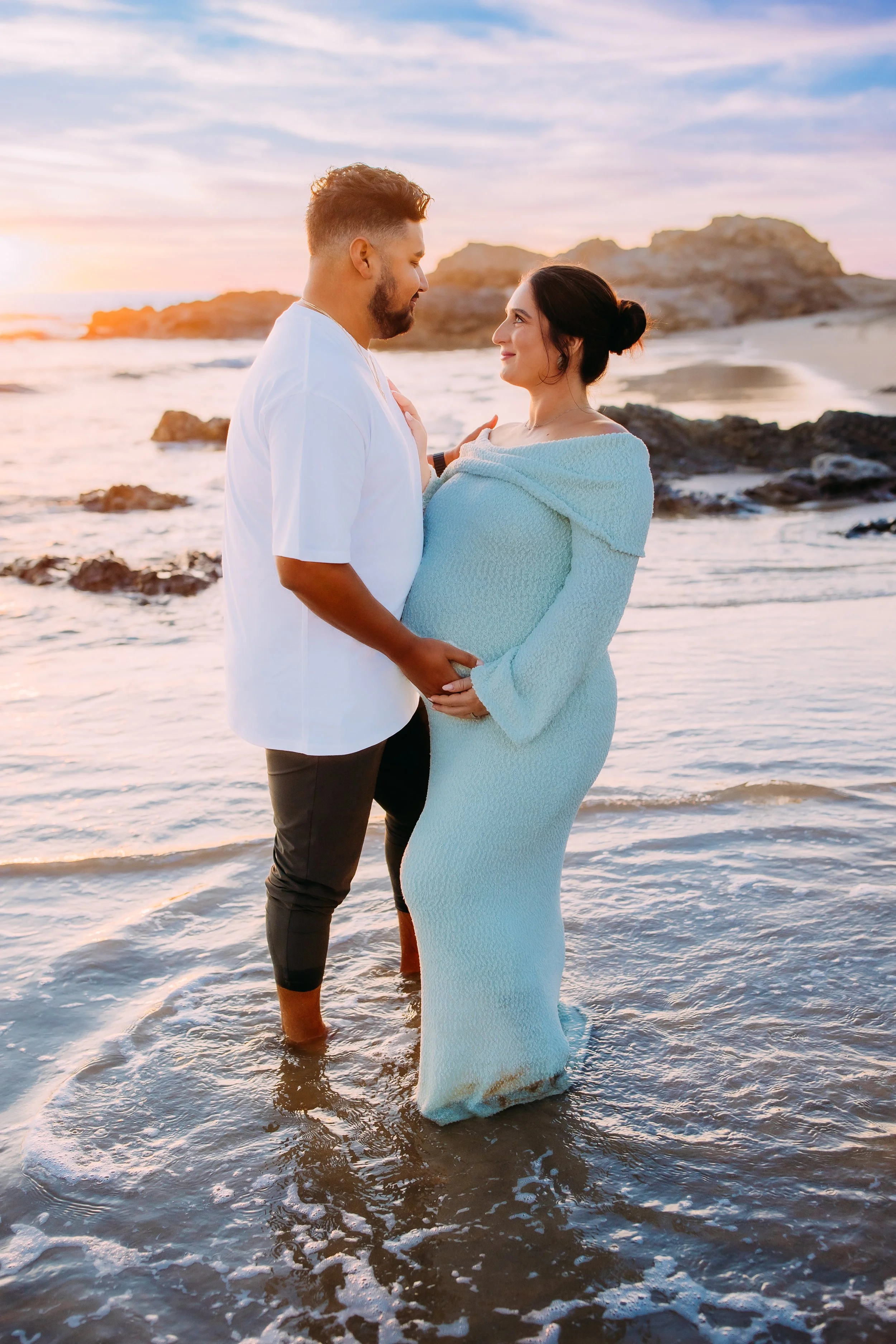 Maternity photos in Newport Beach at sunset with glowing mom and couple on beach