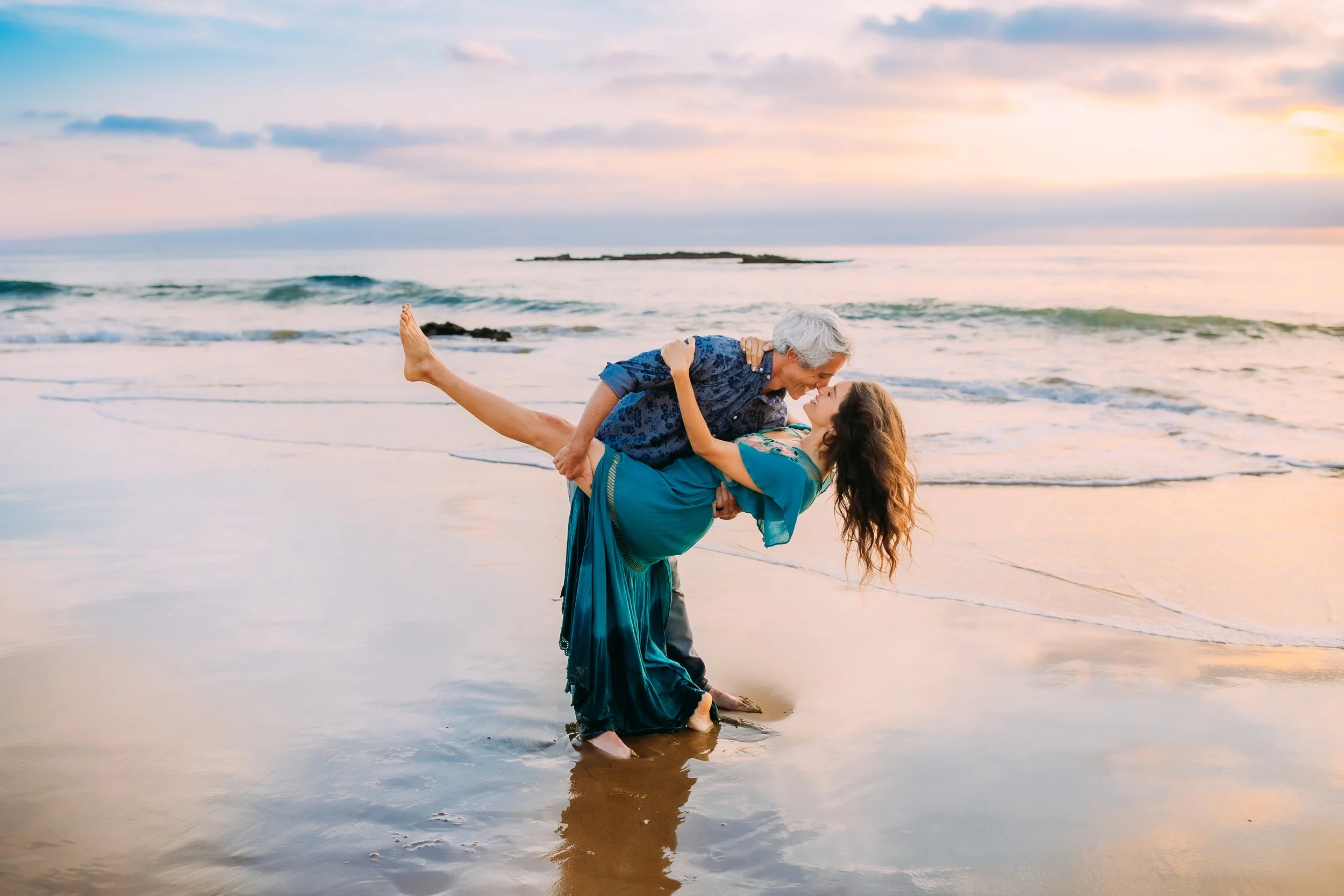 man dipping woman during a photo session at Newport Beach, California