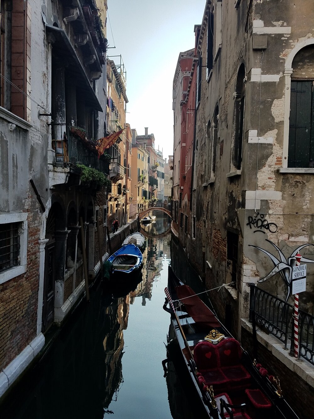 A quiet canal with a gondola in waiting