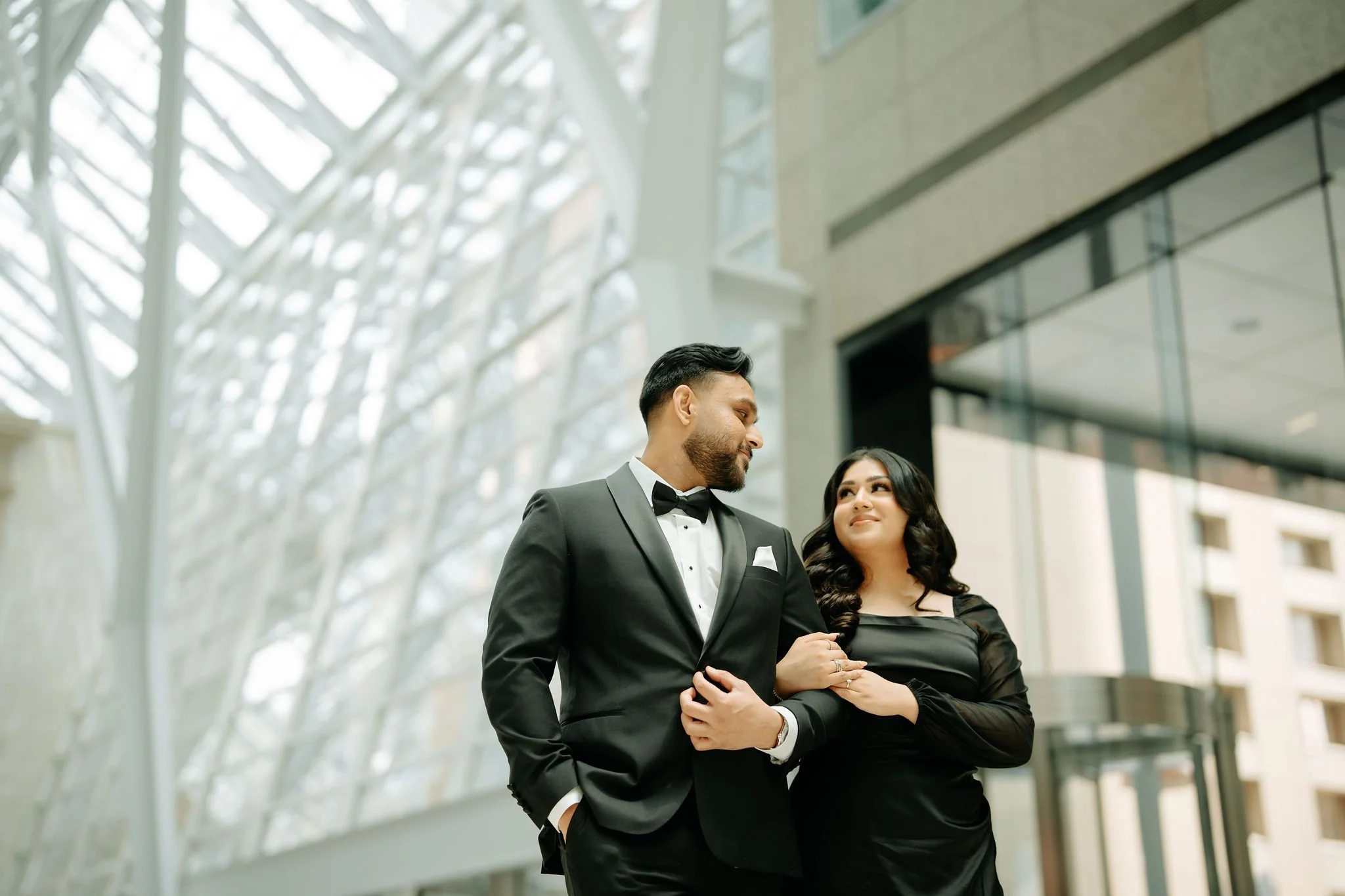 Toronto Muslim wedding photographer – elegant engagement portrait near historic building.