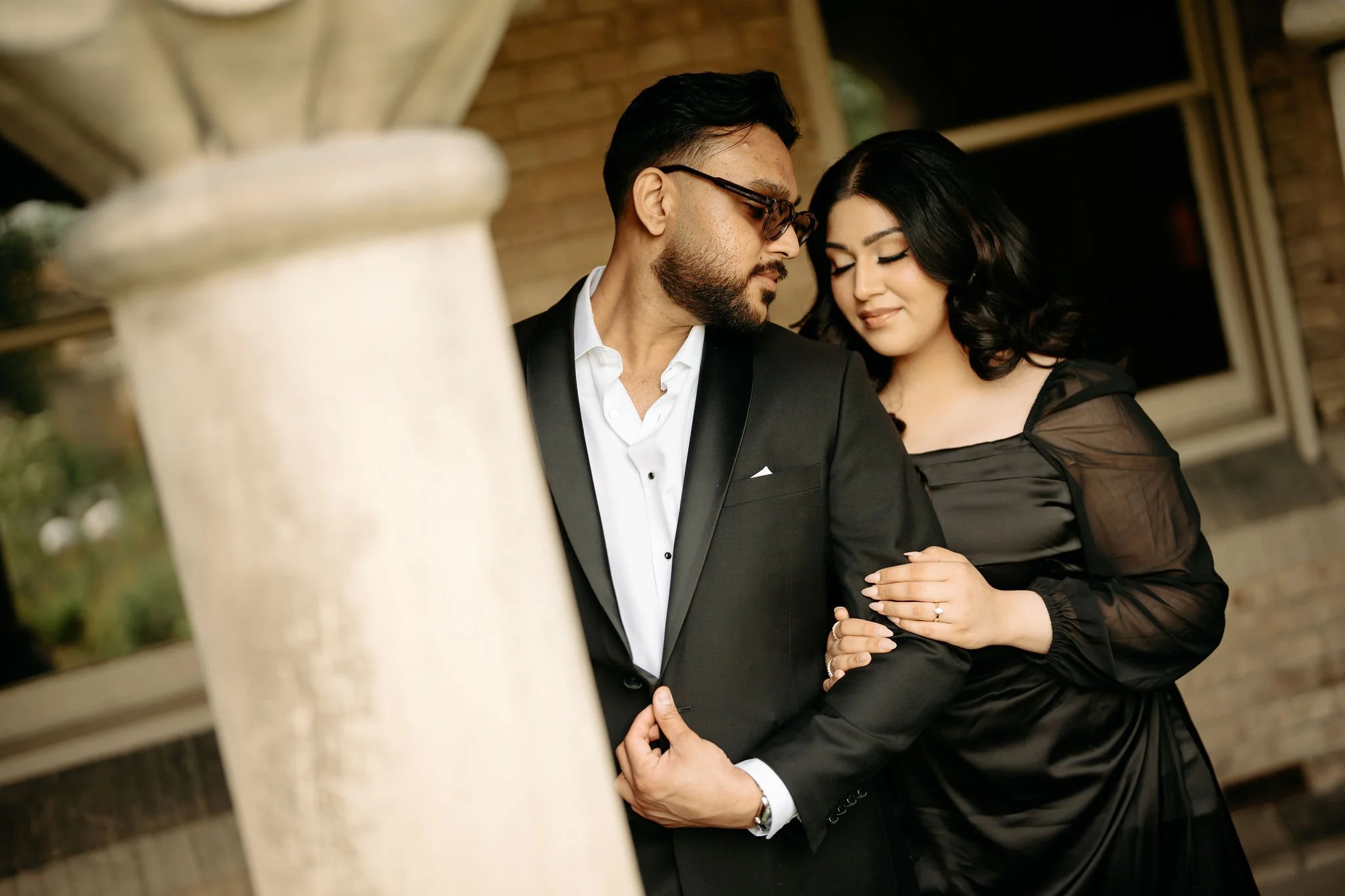 Cinematic Muslim engagement shoot in Toronto – couple portrait in black attire with elegant styling.
