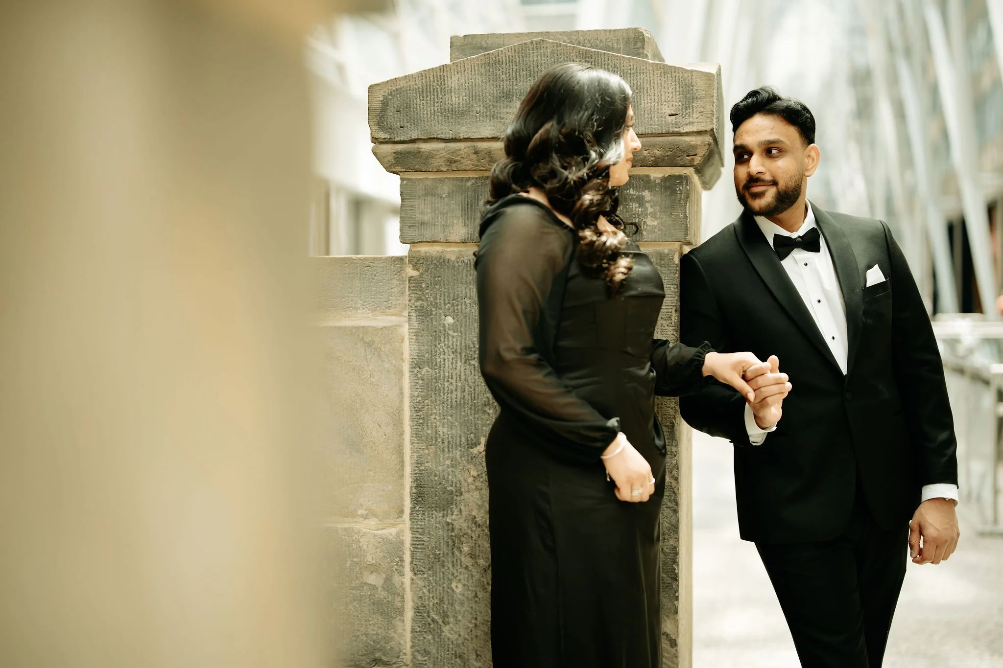 Muslim wedding engagement photography Toronto – couple walking in park setting in black formal wear.