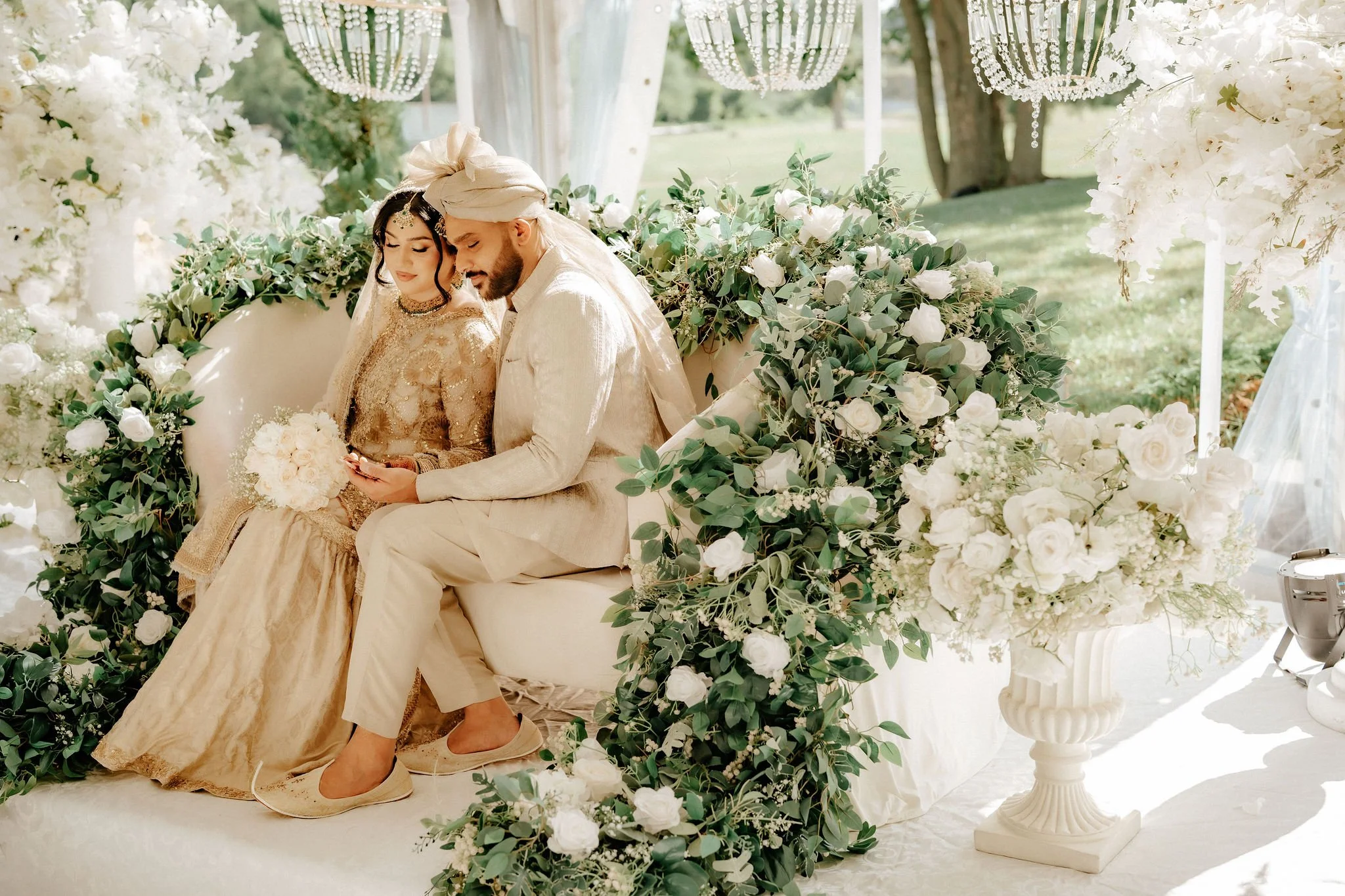 Toronto Muslim wedding photography – bride and groom in gold traditional attire in outdoor garden.