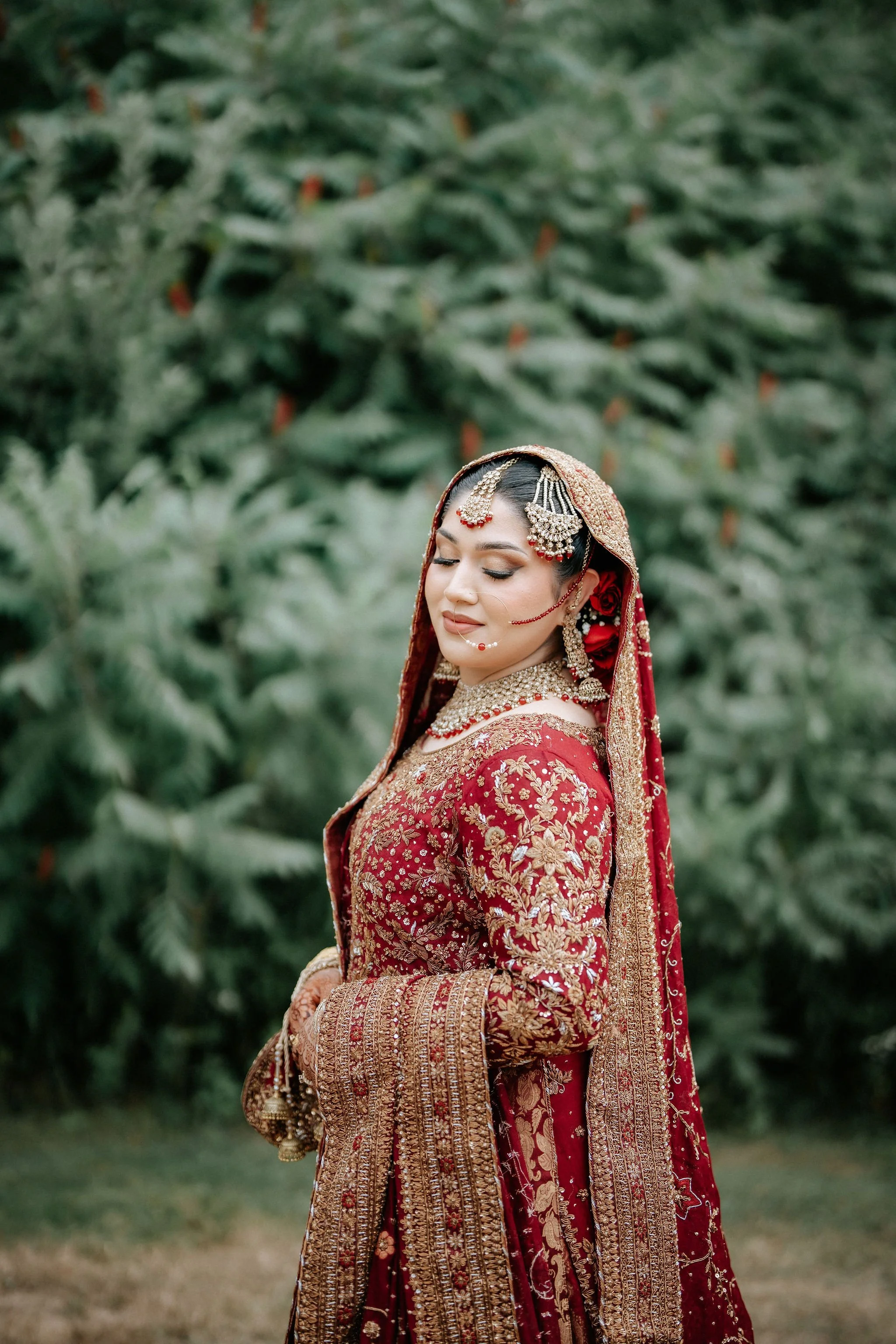 Luxury Muslim bridal photography Toronto – detailed portrait of bride in red wedding attire and jewelry.