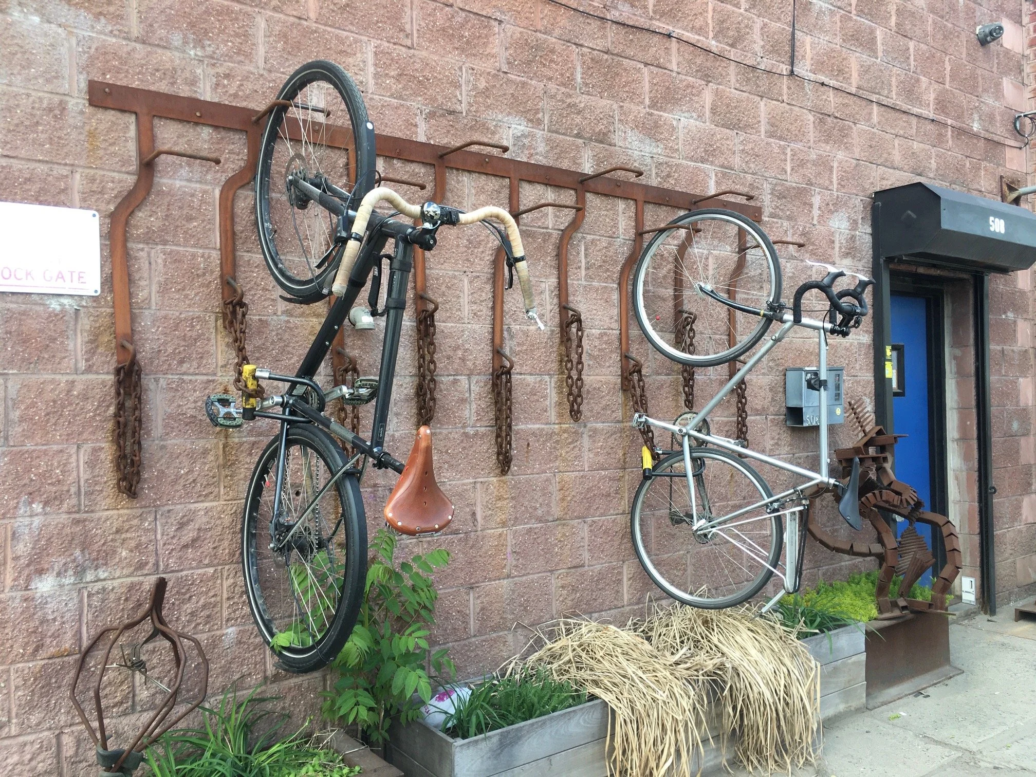 Exterior wall at 618 Design with custom bike racks and metalwork.