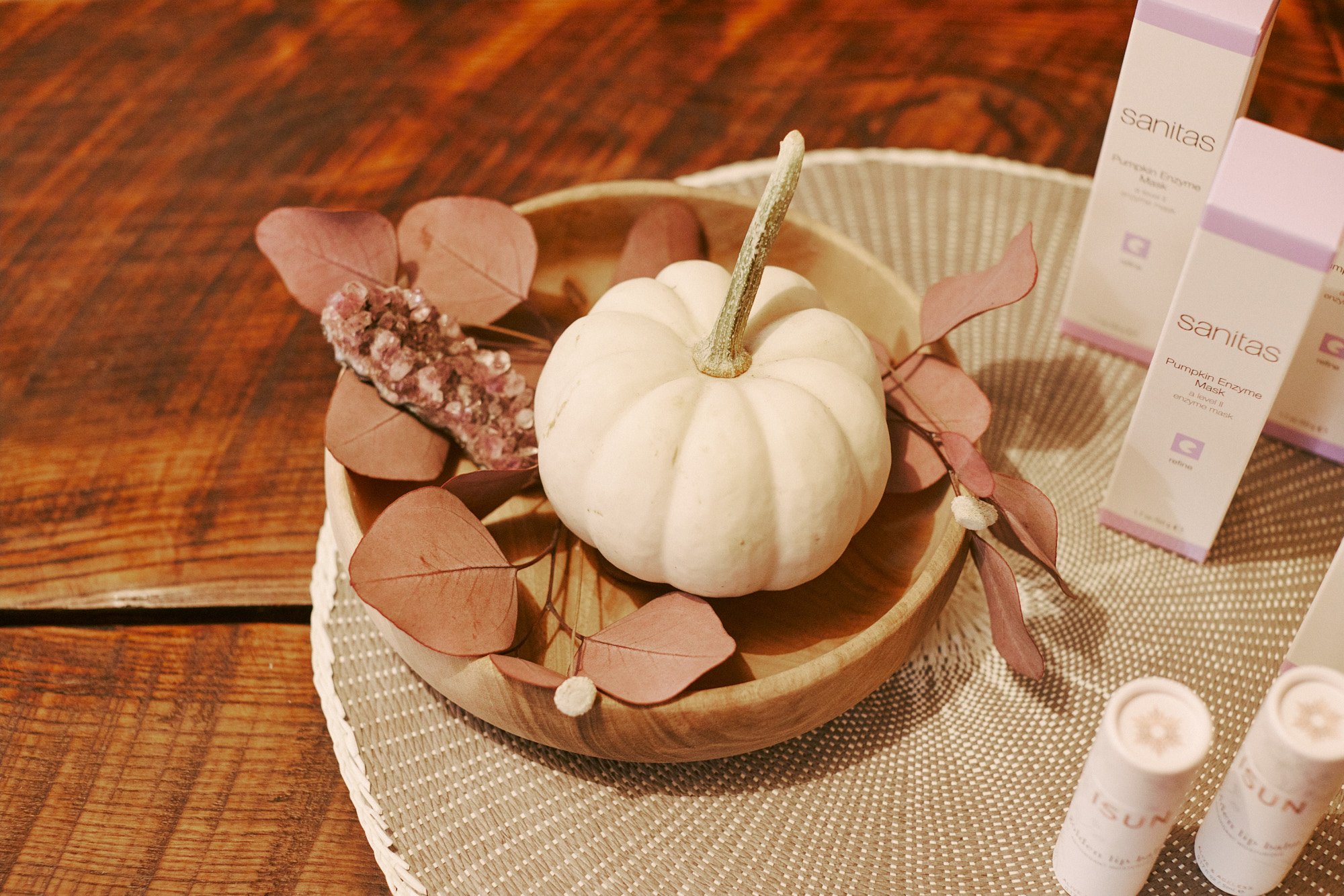 Pumpkin Harvest Facial products with a white pumpkin at Mandara Spa in Fort Collins